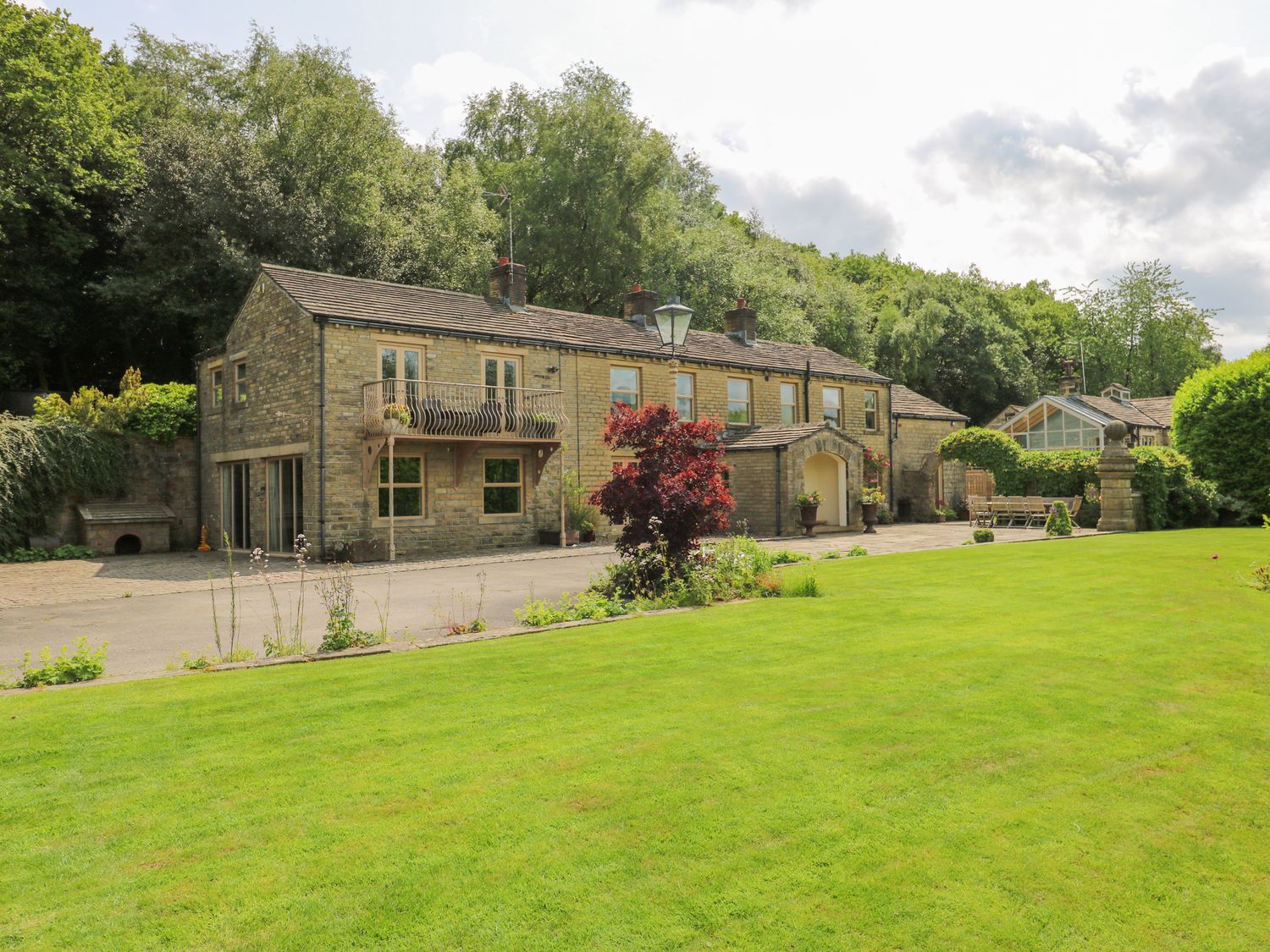 A house with a garden and pathway at Woodbottom Farm in Meltham