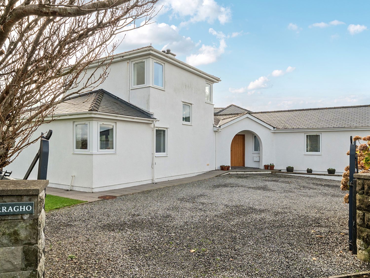 A house with a driveway and gravel area at Curragho Trearddur Bay