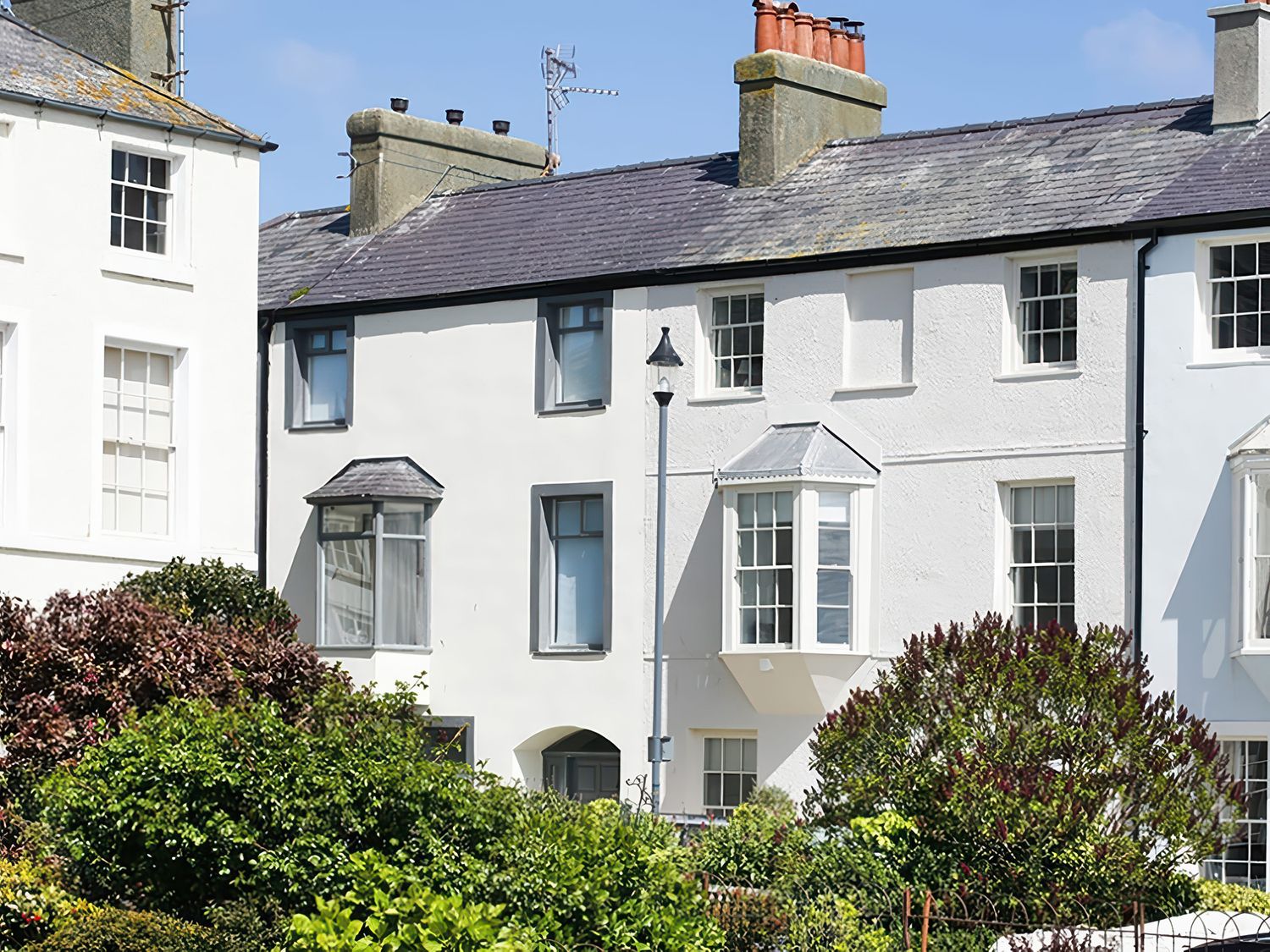 A view of houses and greenery at Tri Raglan Mawr in Beaumaris