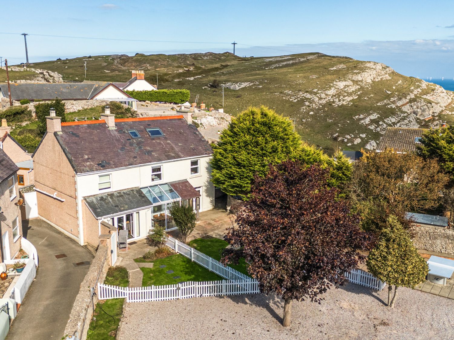 A house with a garden and trees at Ty Bach, Great Orme, Llandudno