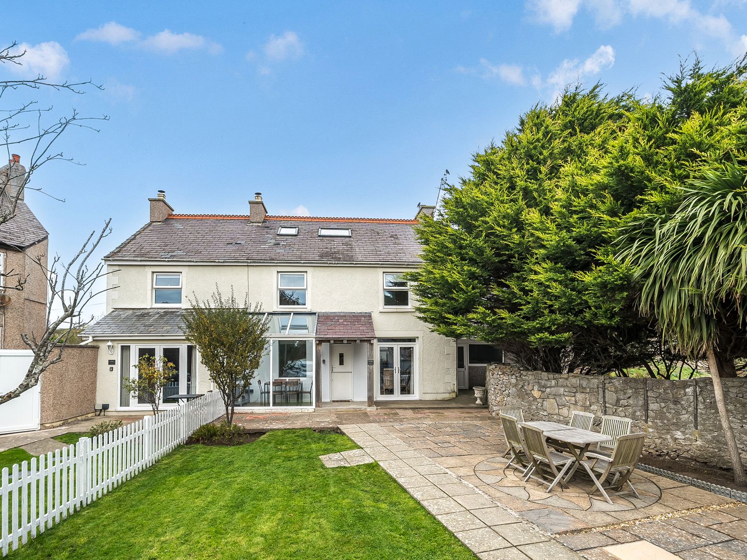 A garden with a house and outdoor seating at Ty Mawr, Great Orme in Llandudno