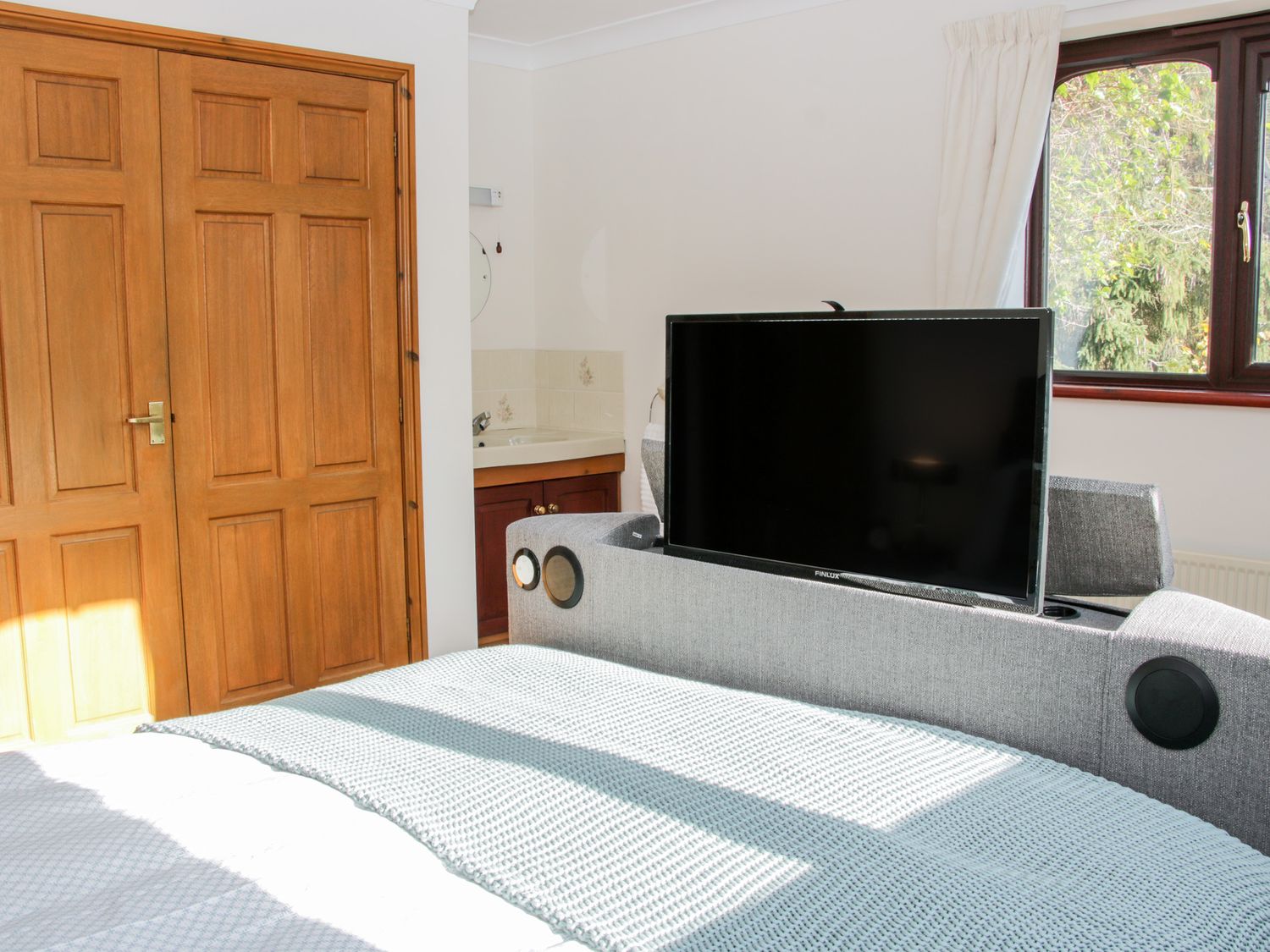 A bedroom with a bed and a television at Court Farm Neen Sollars near Cleobury Mortimer