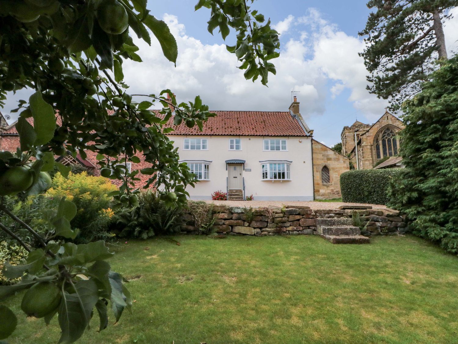 A house with a garden and trees at Weavers Cottage Carlton-in-Cleveland near Stokesley