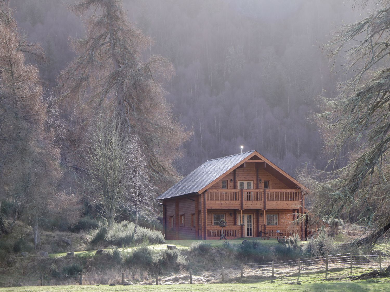 A wooden cabin surrounded by trees in a forested area at Allt Lodge Balnain near Drumnadrochit Loch Ness