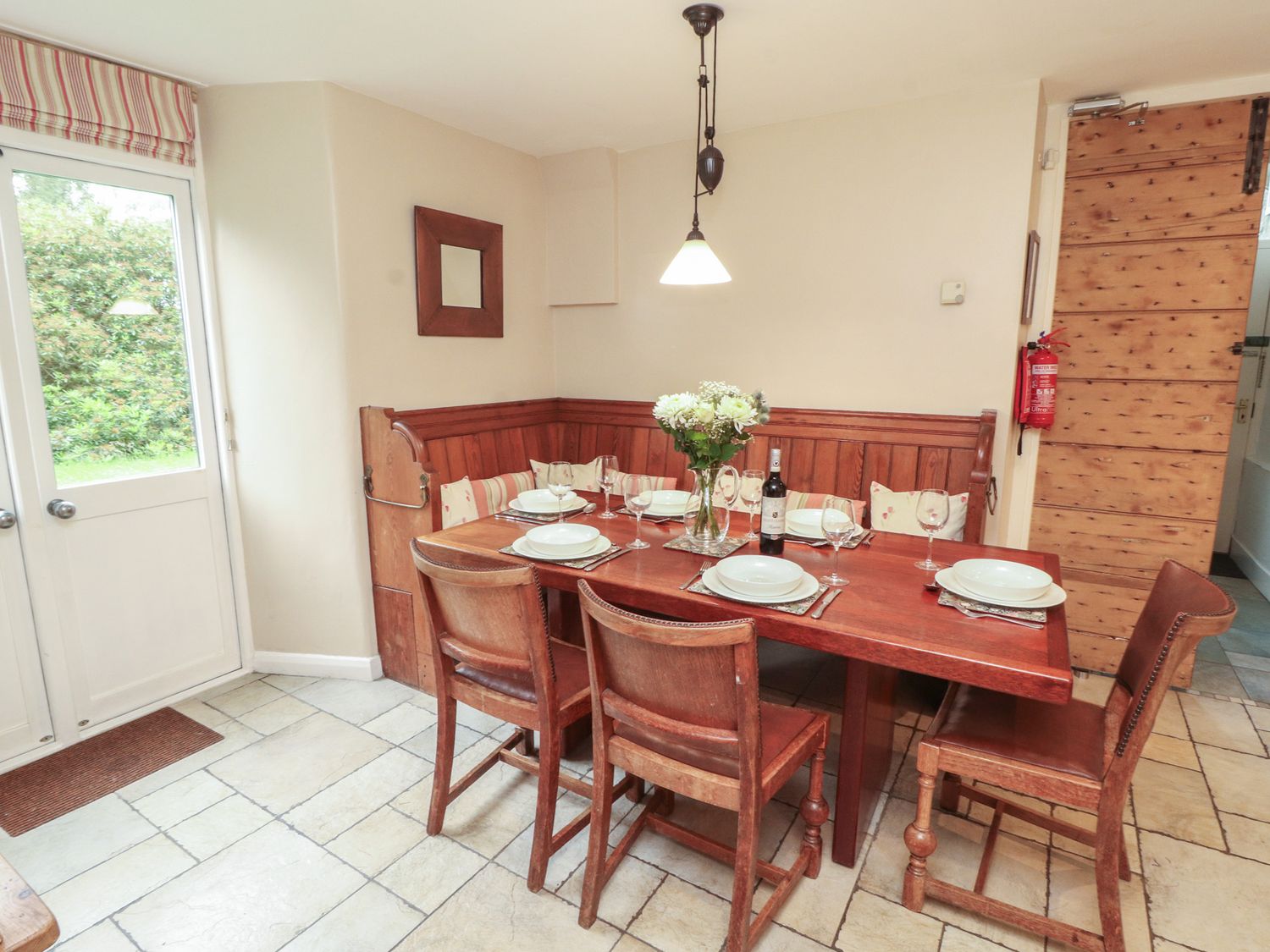 A dining room with a table set for dinner at Chapel How in Ambleside