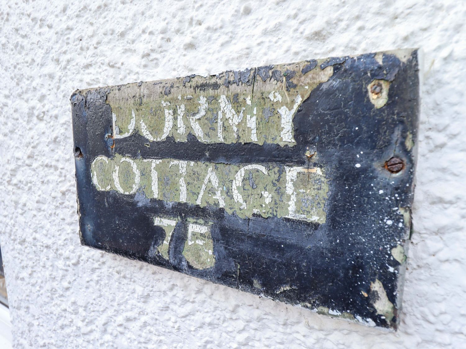 A sign displaying Dormy Cottage 76 located outdoors at Dormy Cottage Skegness