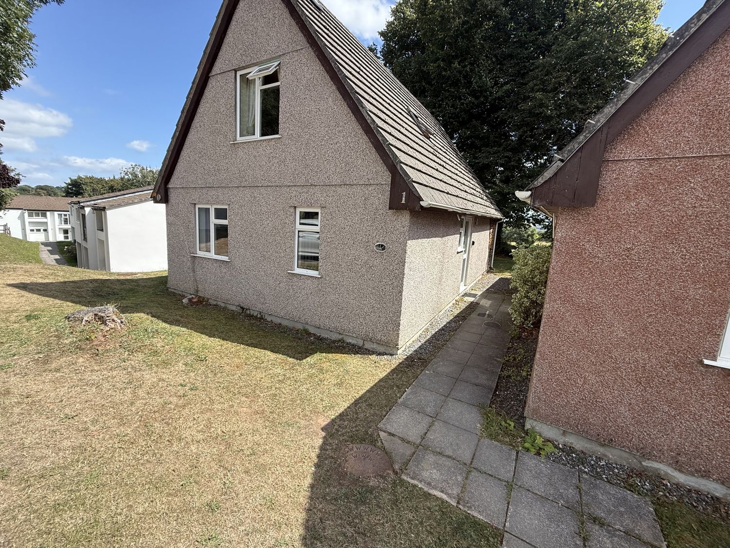 A house with pathway and grass at Hembry Meadows in Honicombe Park near Gunnislake