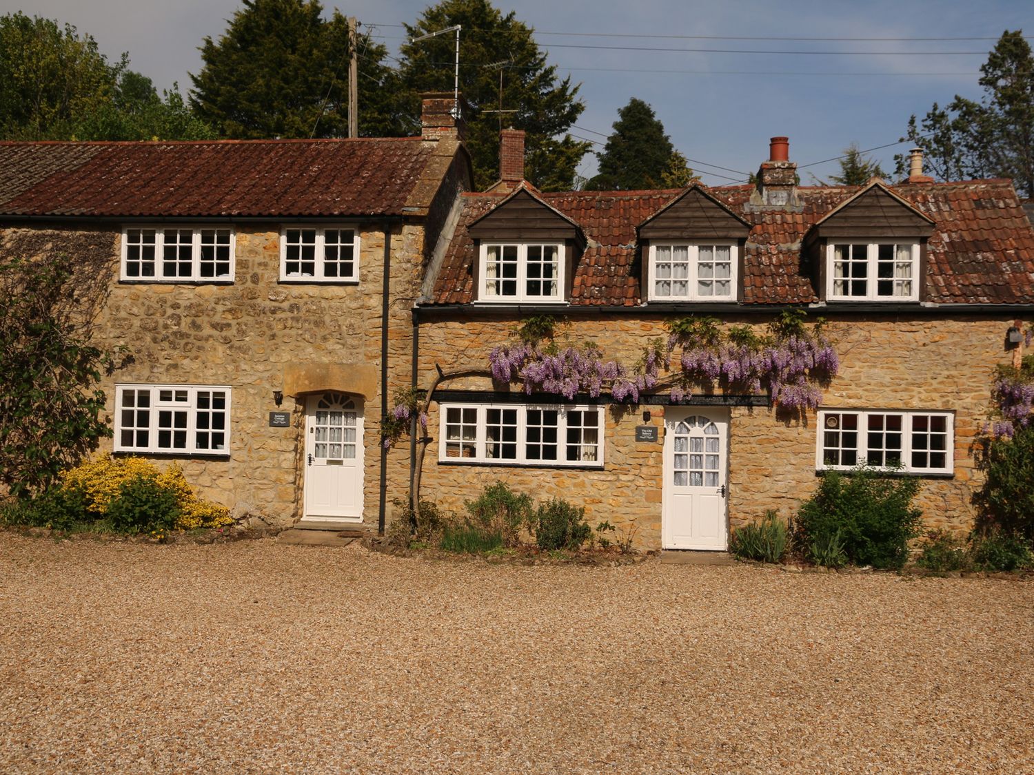 A cottage with windows and a door at Jasmine Cottage in South Perrott near Mosterton