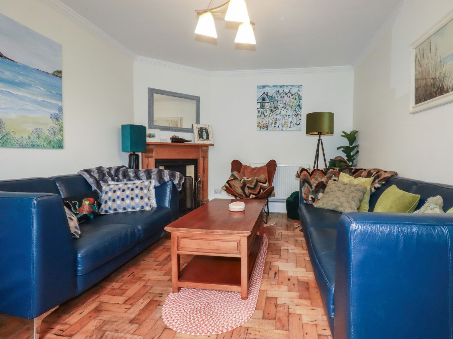 A living room with sofas and a coffee table at Trevethen Cottage in Crantock