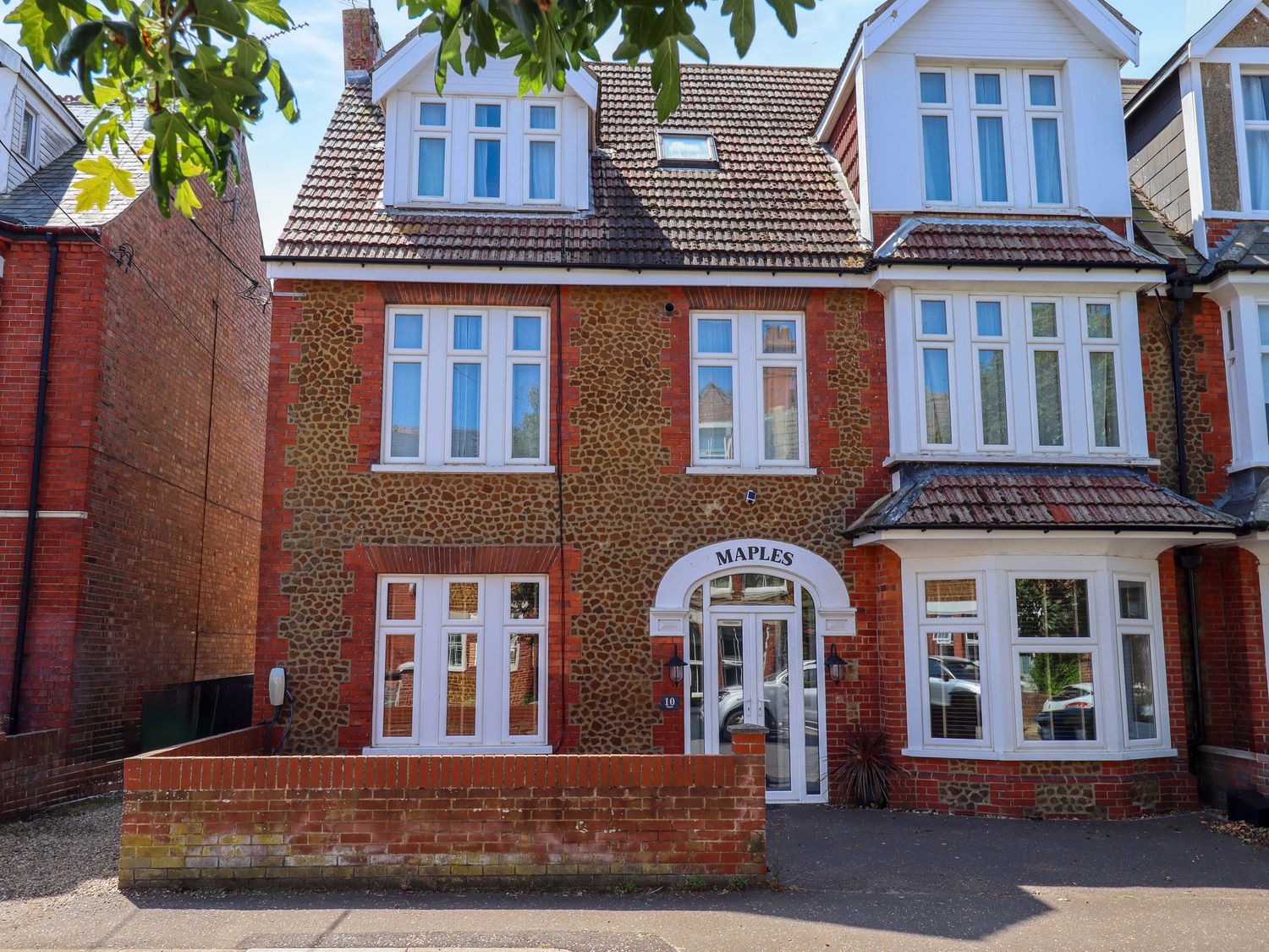 A building with multiple windows and a front door at Maples in Hunstanton