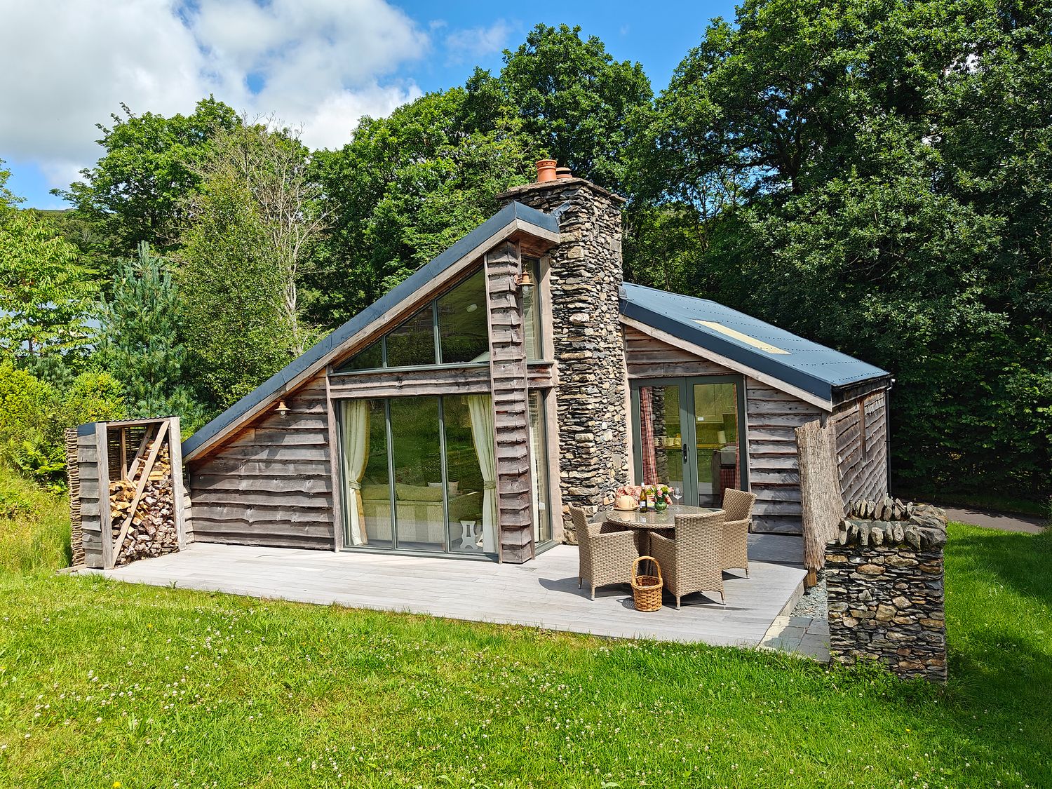 A cabin with a deck and outdoor seating area at The Badger's Shack, Garnett Bridge, Longsleddale. Near Kendal
