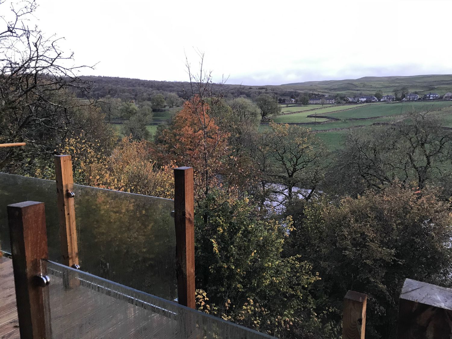 A view of a landscape with trees and a stream at The Sett on the Wharfe, Skipton