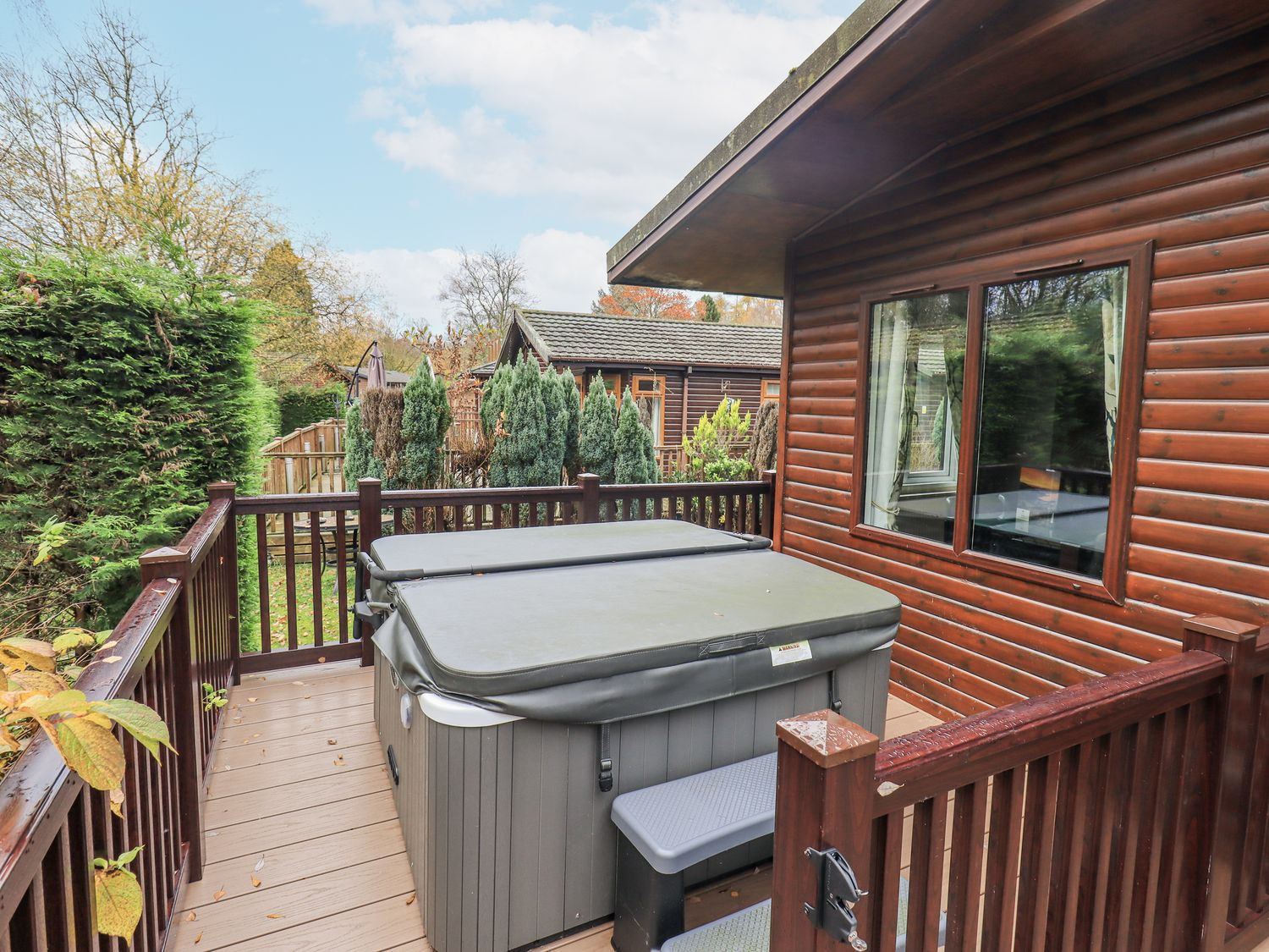 A hot tub on decking at Damson Lodge Thirlmere 8, White Cross Bay, Windermere