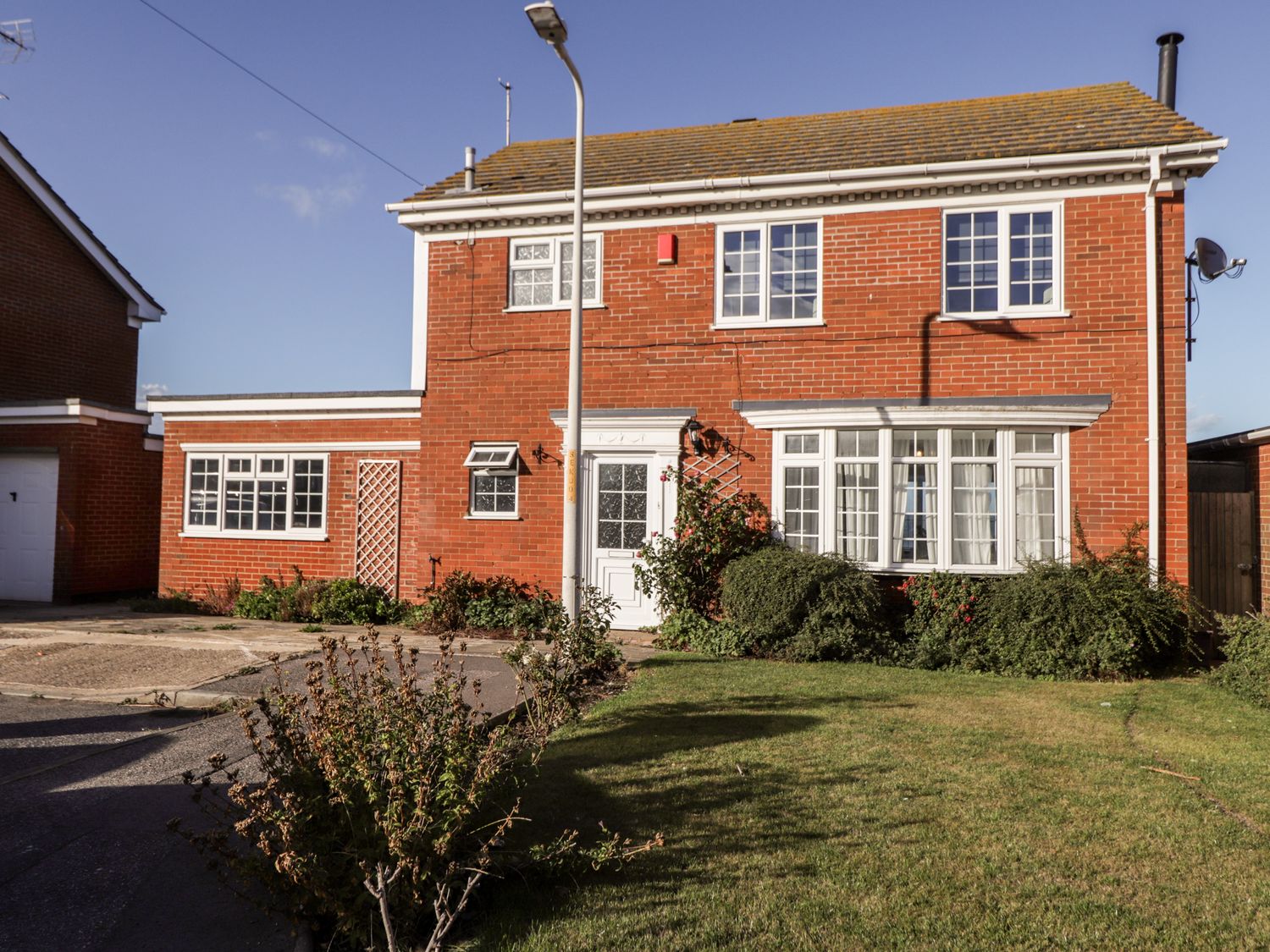 A two-story brick house with white window frames and a garden at 17 St Magnus Close in Birchington-On-Sea