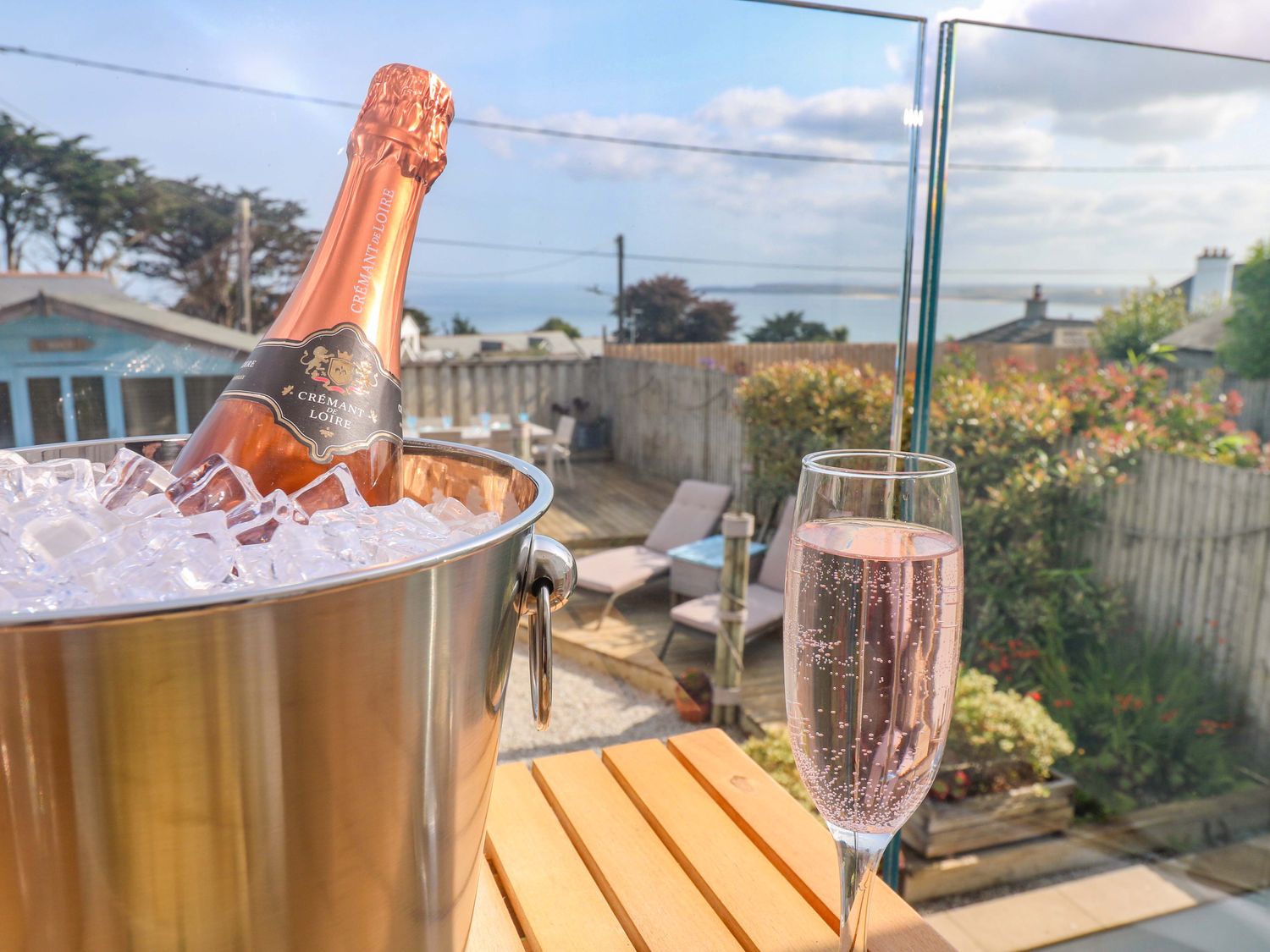A bottle of champagne in ice with a glass at Sea Breeze in Carbis Bay