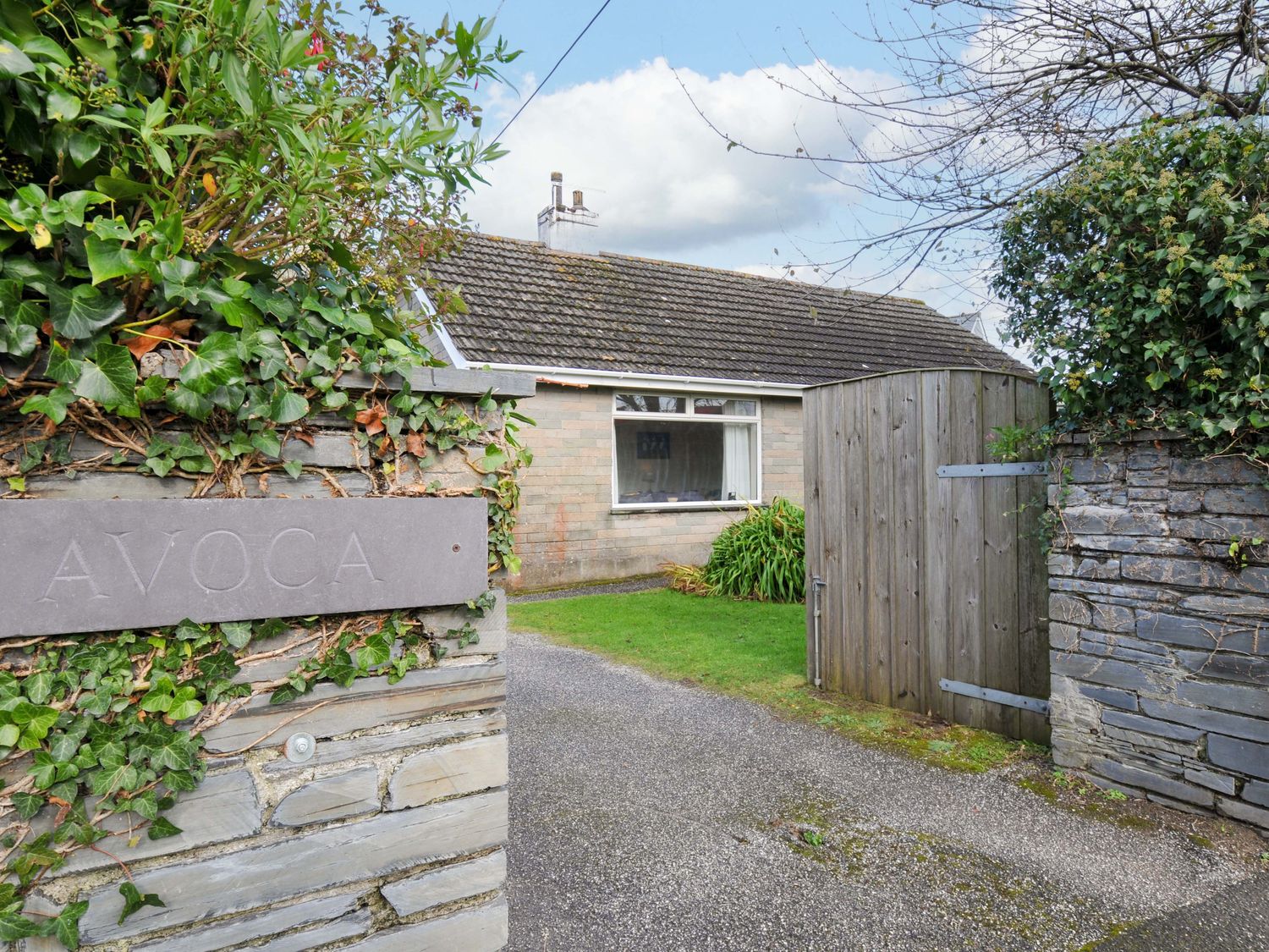 A house entrance with a gate and sign at Avoca in Rock