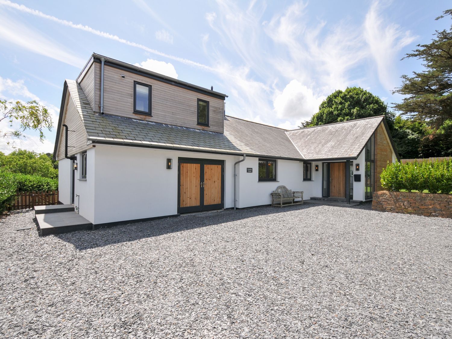 A house with a gravel driveway and outdoor seating at Porthilly Brook in Rock