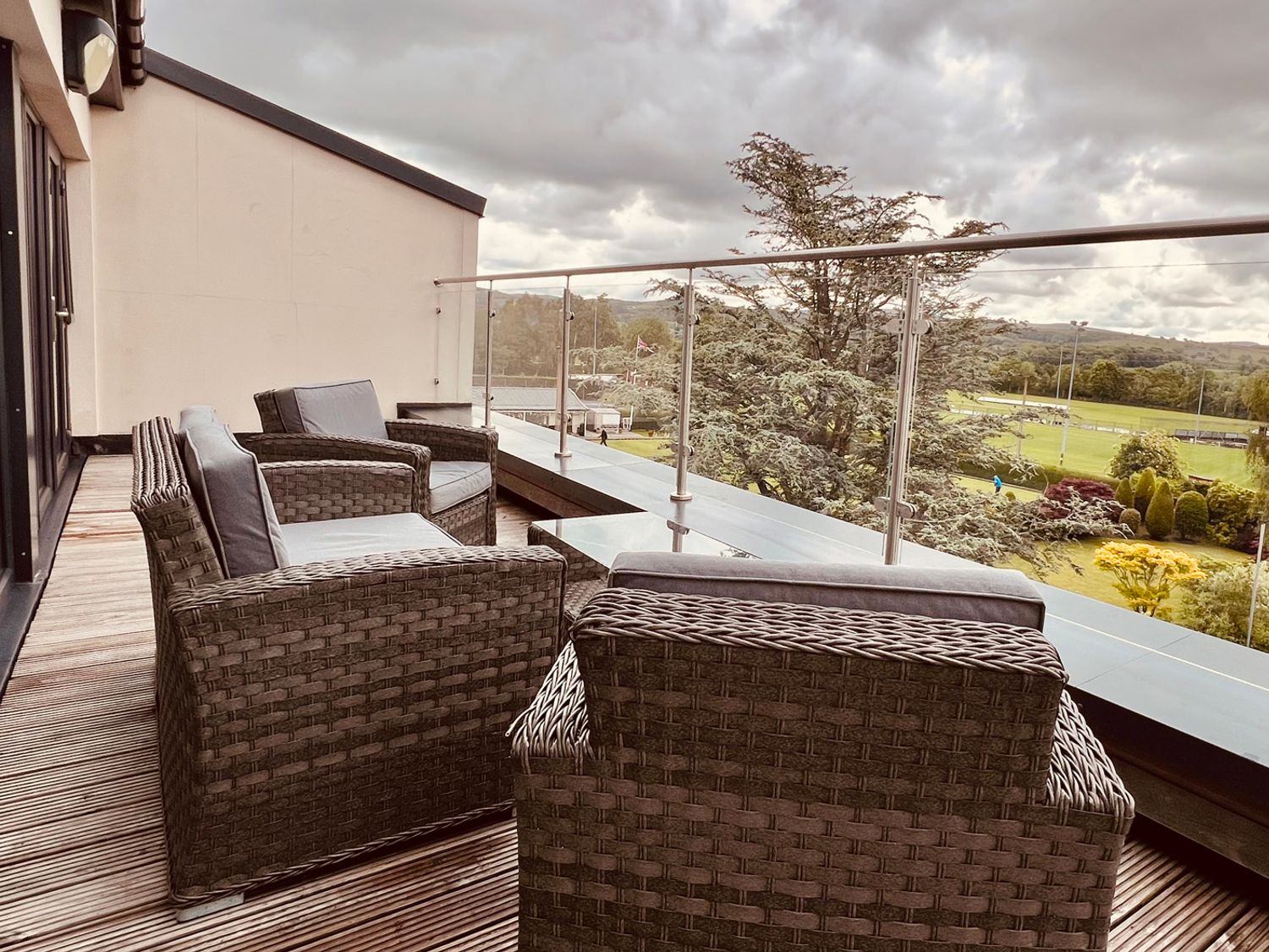 A balcony with chairs and railing at River View in Garstang