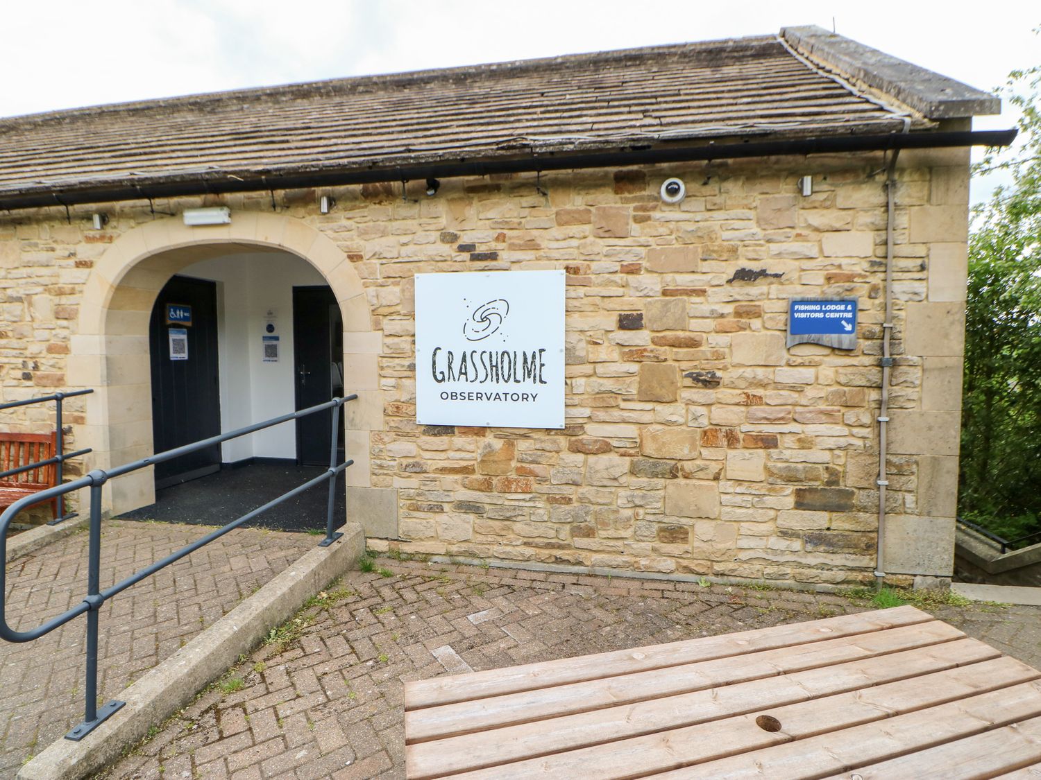 Stone building with a sign reading Grassholme Observatory and a ramp leading to an archway at Grassholme Observatory in Middleton-In-Teesdale