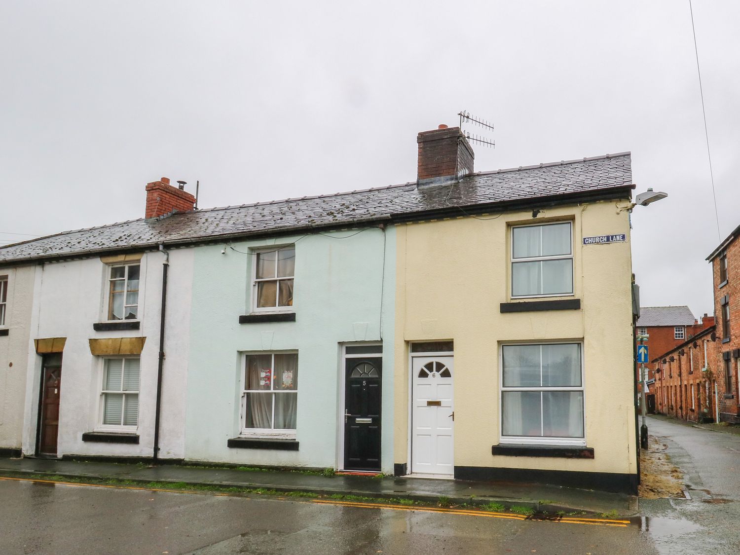 A terraced house with doors and windows on Church Lane in Llanidloes