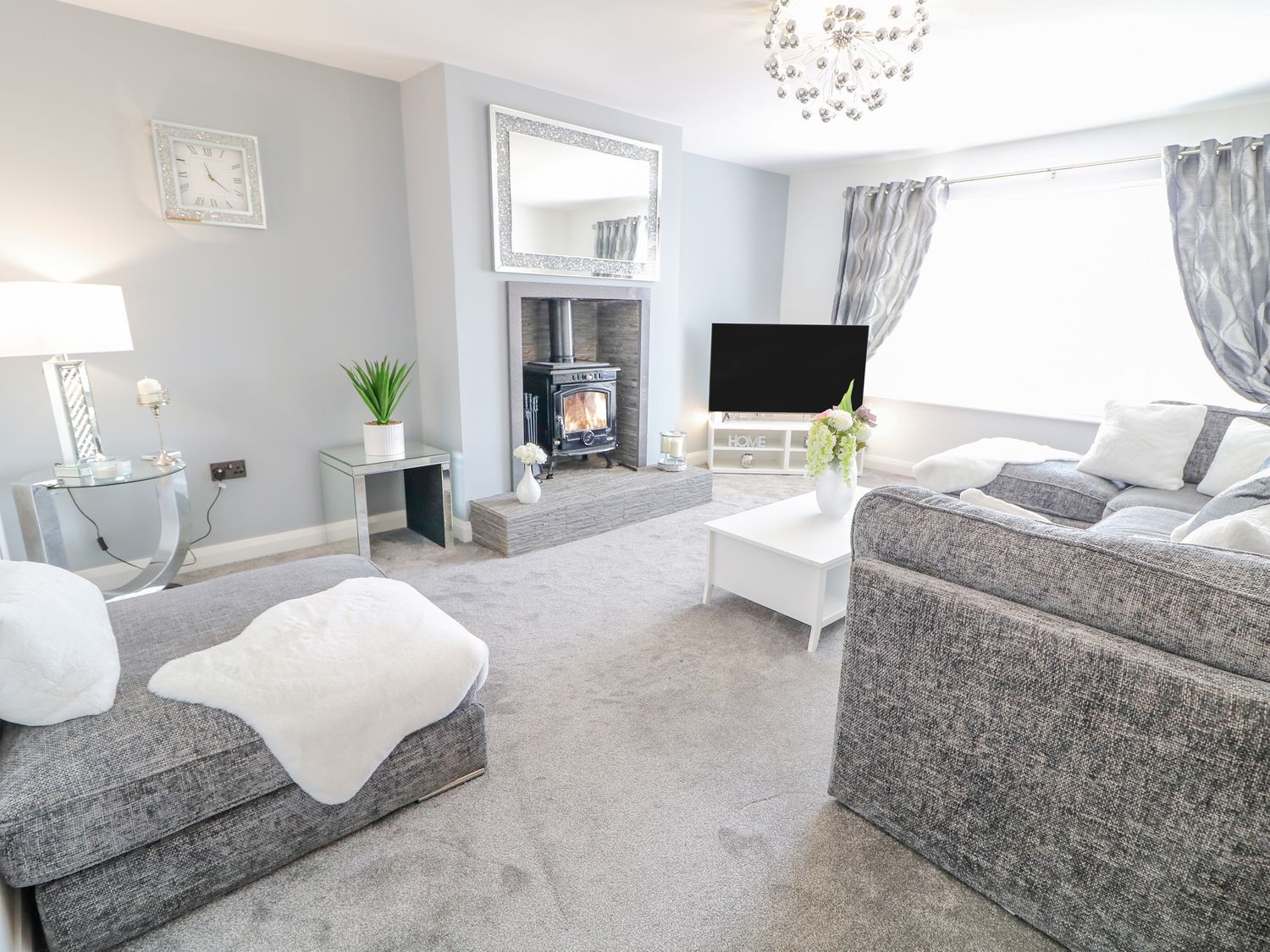 A living room with a fireplace television sofas and a coffee table at SJs Cottage in Castlerock
