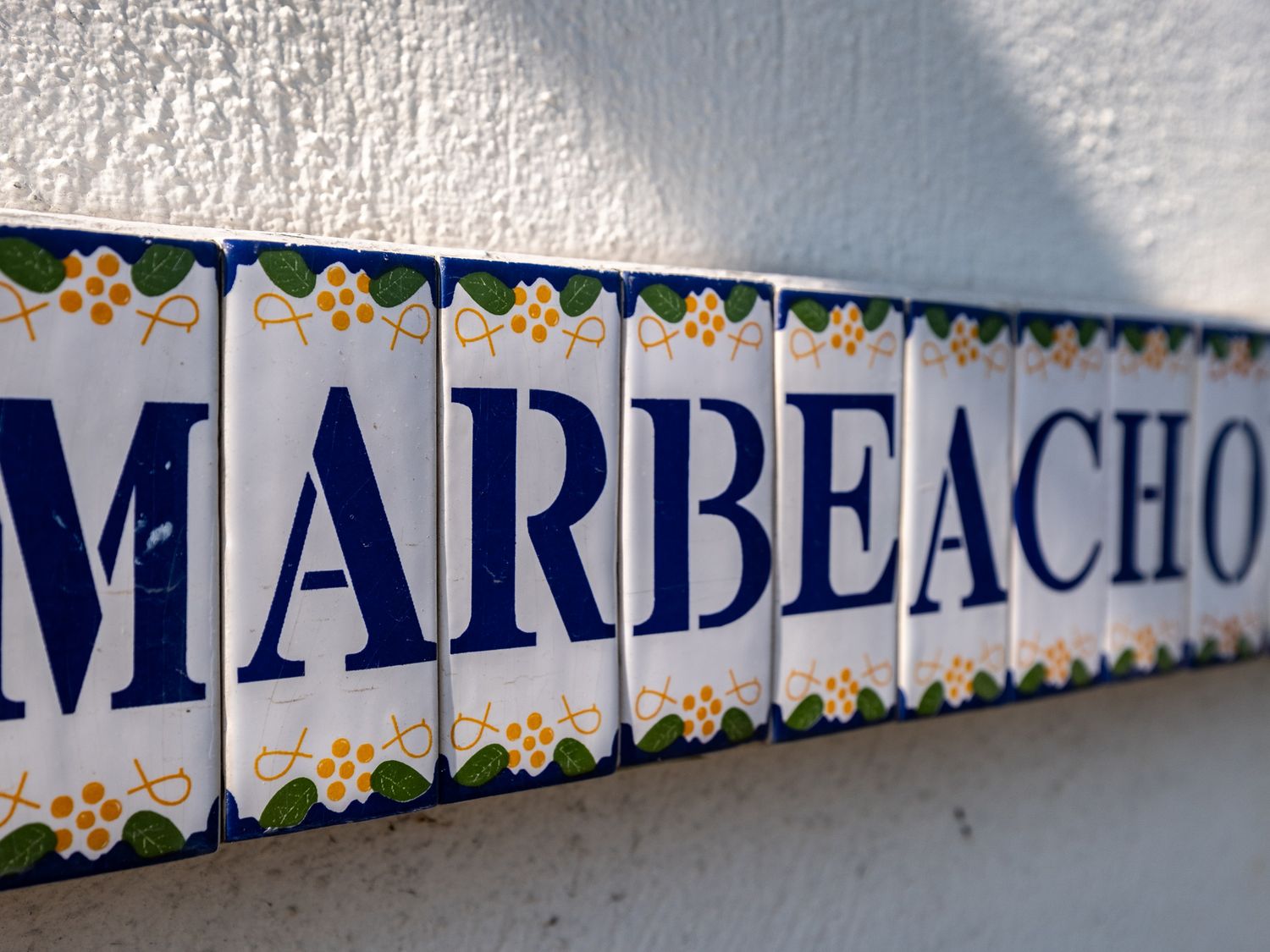 Close up of tiled sign with the word Marbeachow on a textured wall at Tredrizzick near Rock