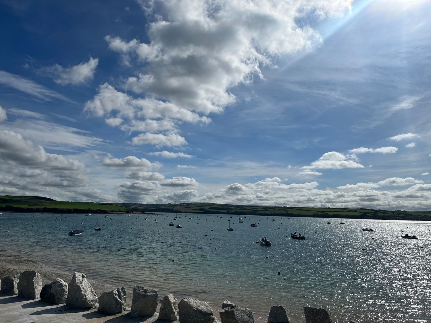 A coastal view with boats on the water and hills in the background at Obos Retreat in St Minver near Rock