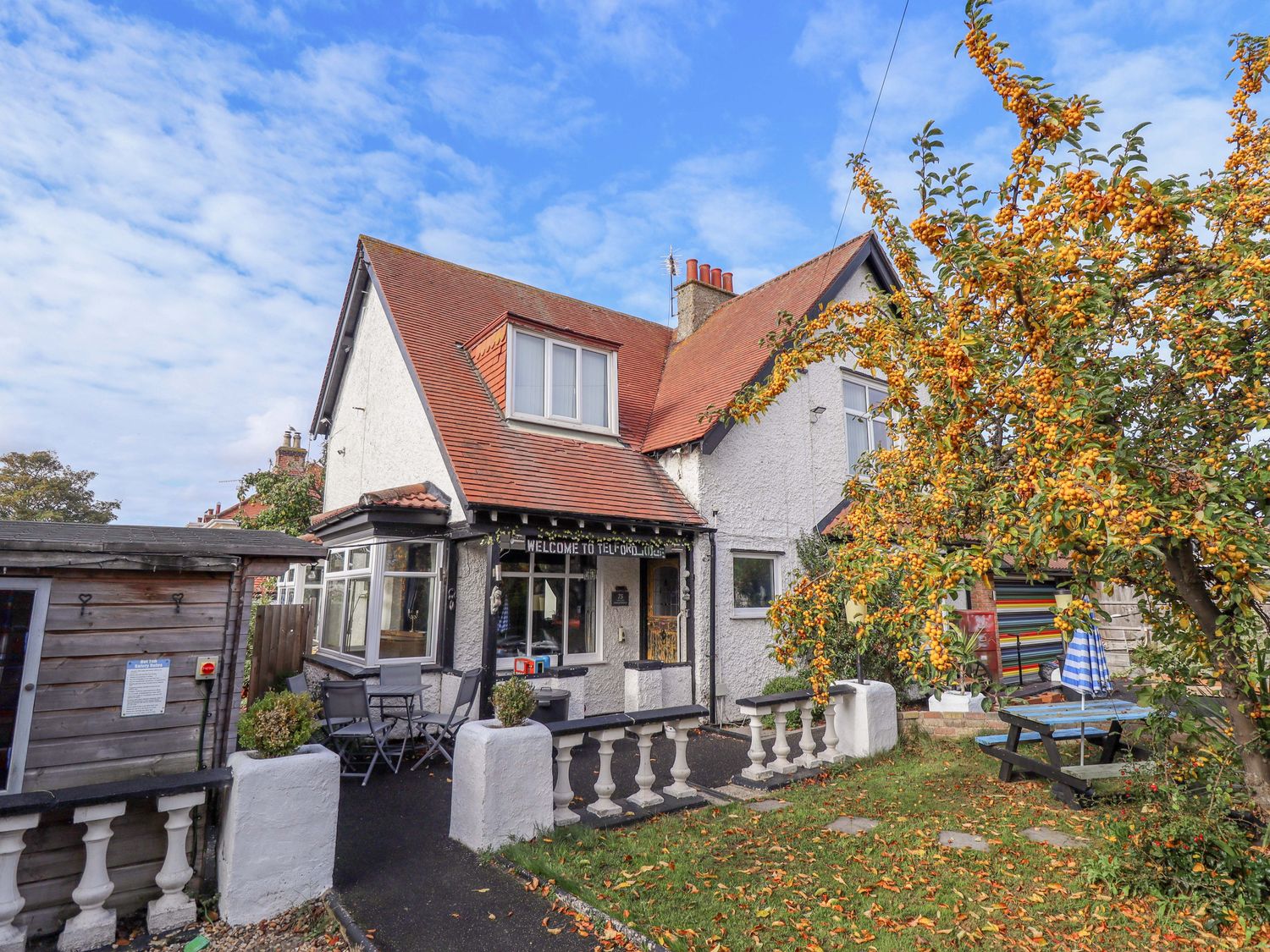A house with a garden and furniture outside at Telford Lodge in Skegness