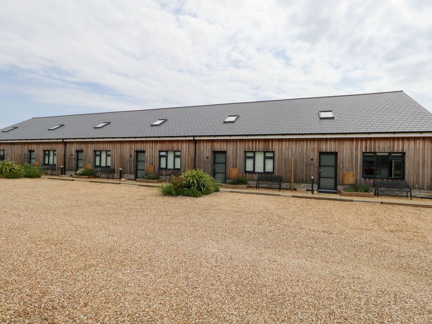 A building with multiple doors and windows at Egdon Heath, Nottington near Weymouth