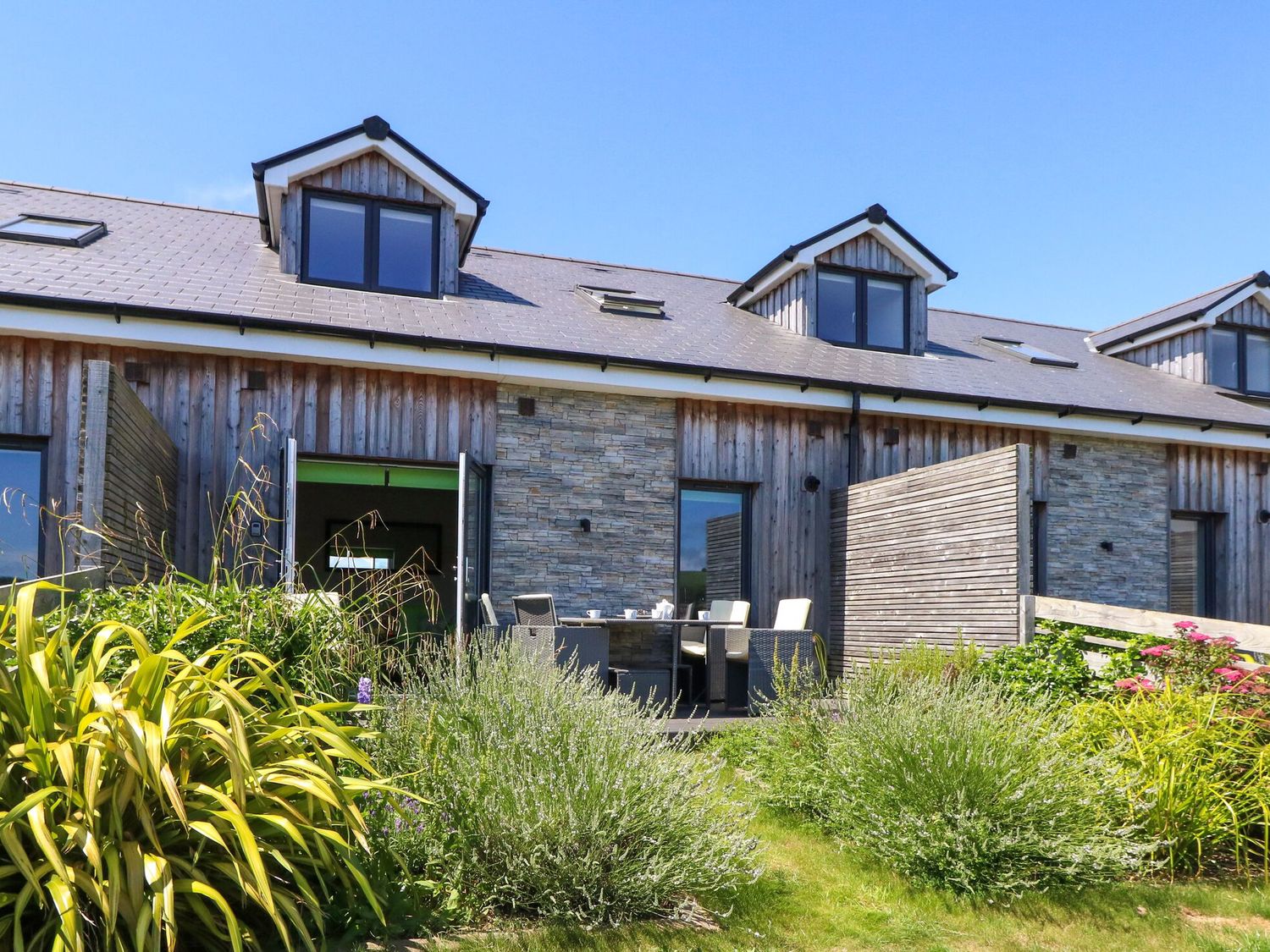 A building with an outdoor seating area and garden at Overcombe Mill Nottington near Weymouth