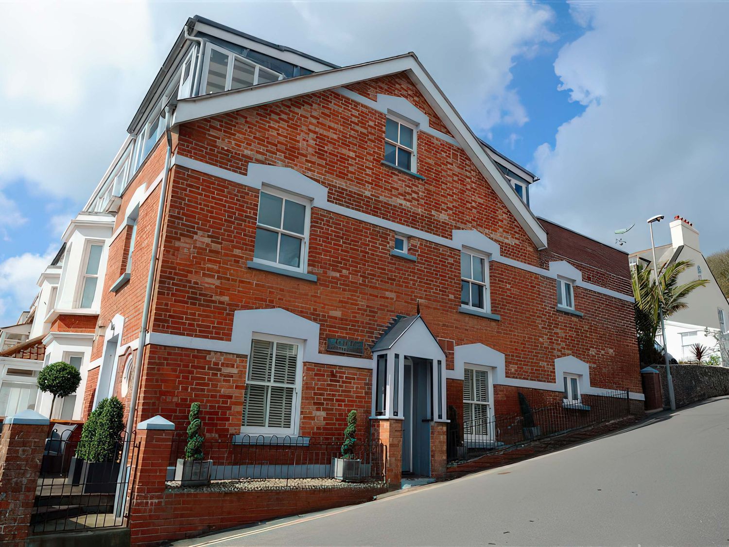 A brick building with windows and landscaping at Seaside in Lyme Regis