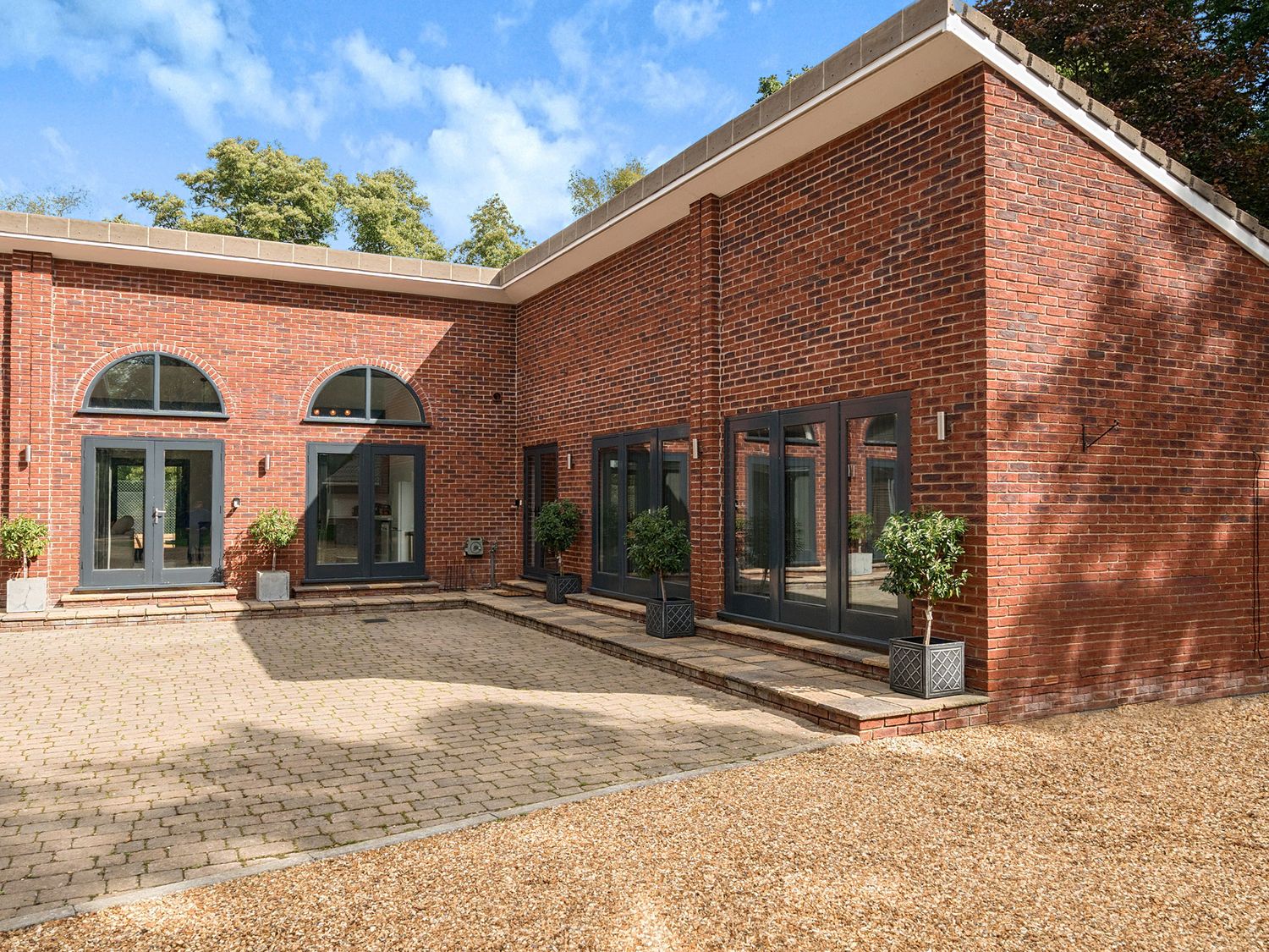 An outdoor area with brick walls and pathways at The Cottage in Wimborne Minster