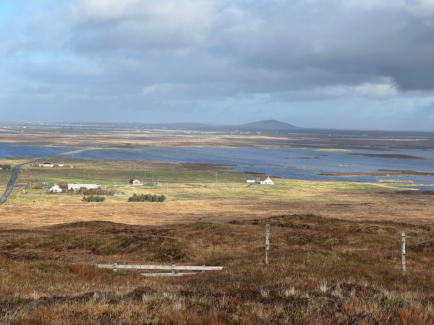 A rural landscape with scattered houses fields and water at Airigh nam Fiadh in Geirinis near Creagorry
