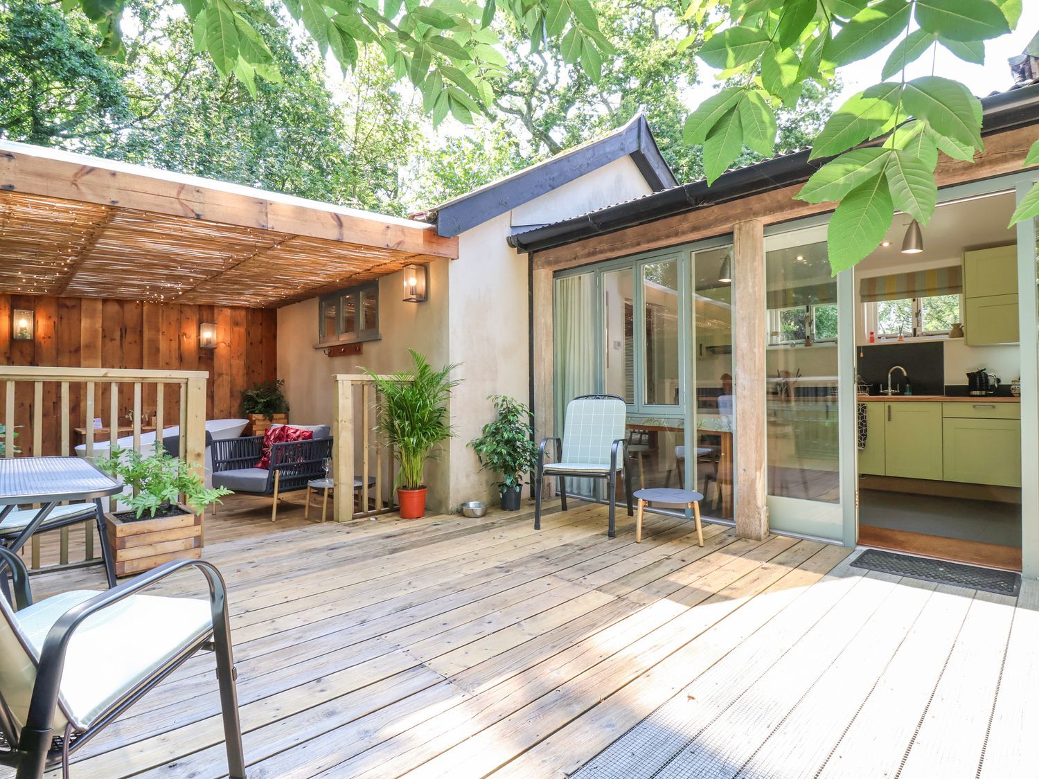 An outdoor area with seating and kitchen view at Yew Tree Farm Barn and Stable Framlingham