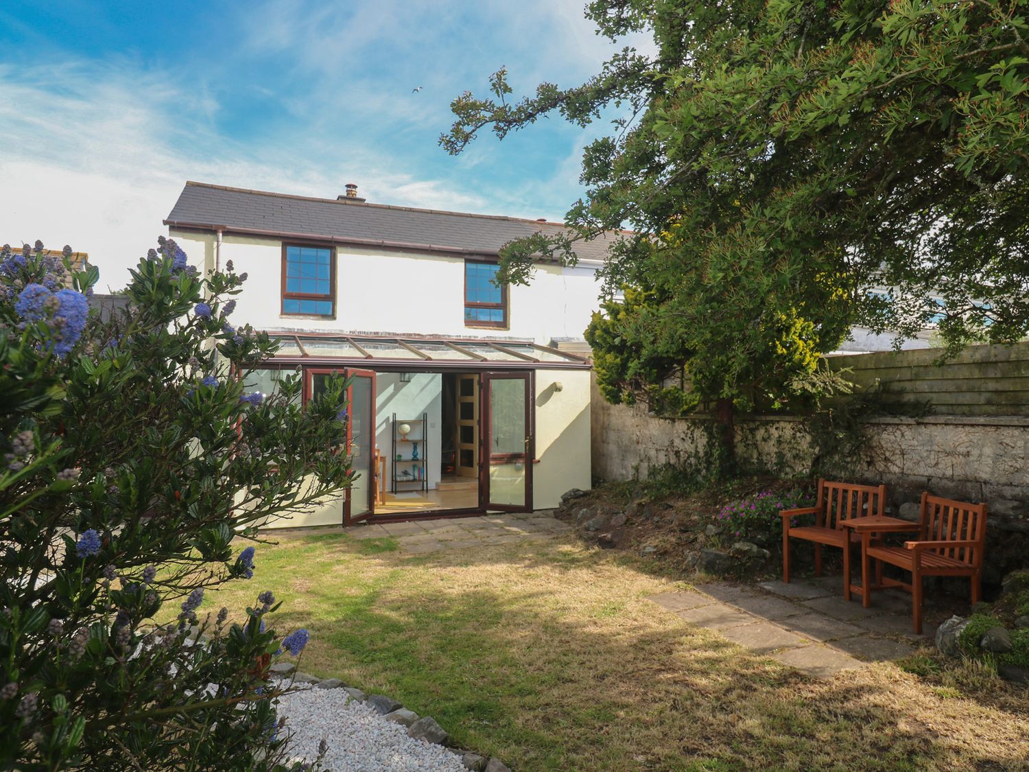 A garden with a house and conservatory at Candle Croft, Tolgus Mount near Redruth