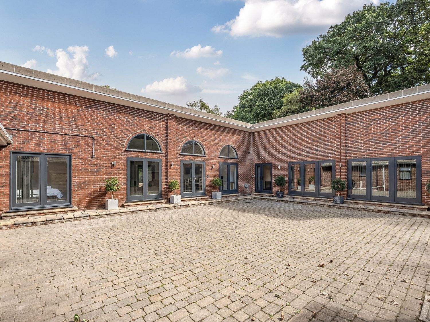An outdoor area with brick walls, windows, and paved flooring at The Annex Wimborne Minster