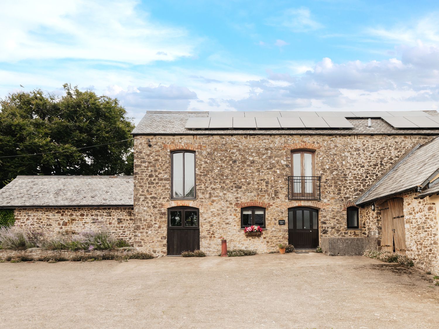 A building with windows and a driveway at Hoppers Barn Pancrasweek near Holsworthy