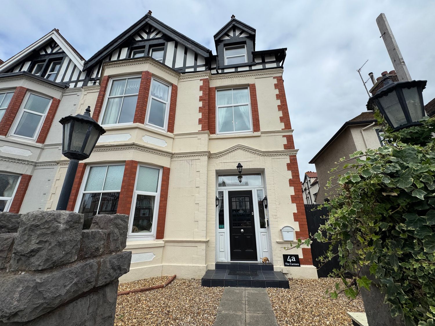 A house with a black front door and windows at The Causeway 