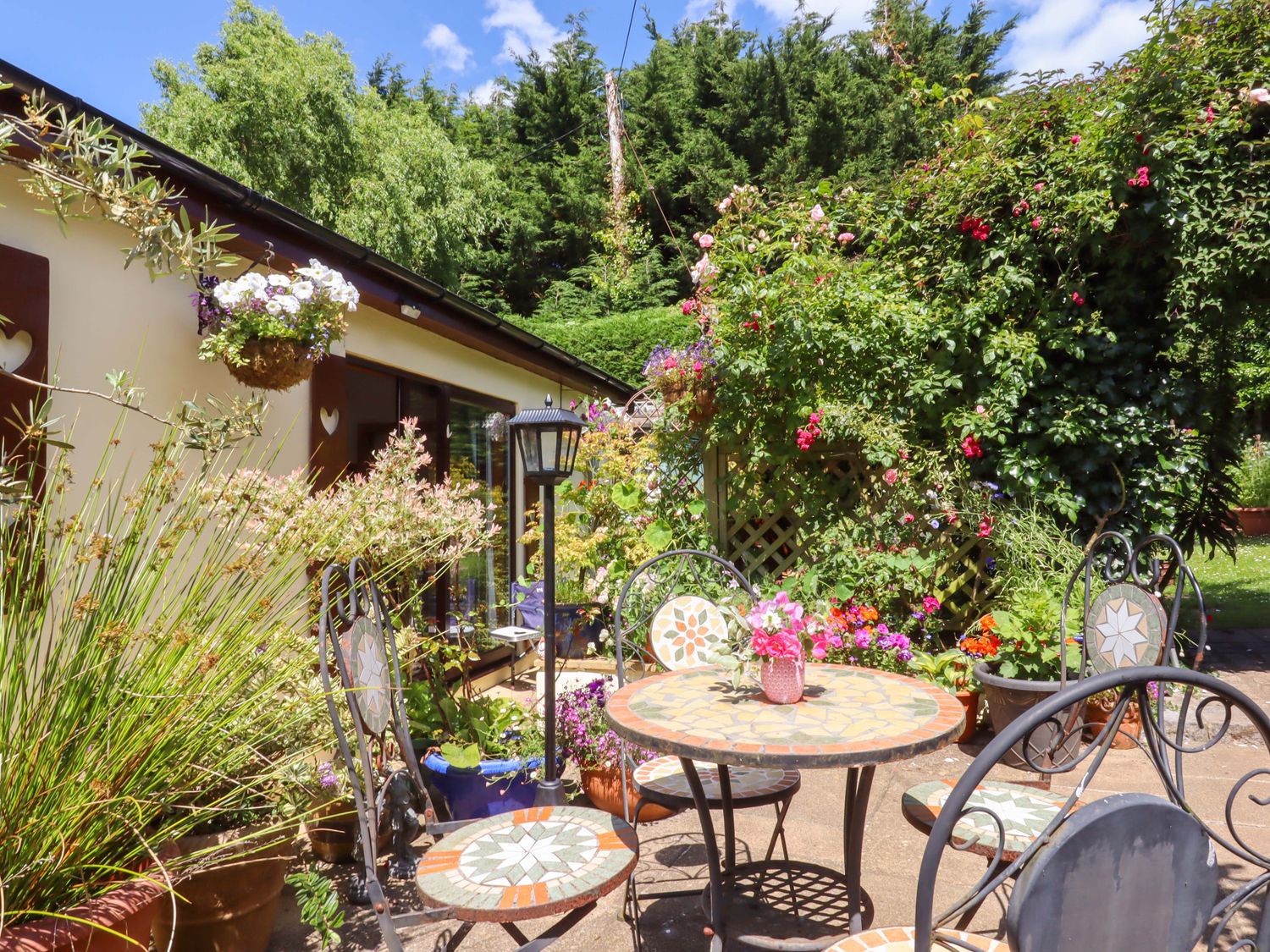 A patio area with a table and chairs at Turnpike Lodge in Brixham