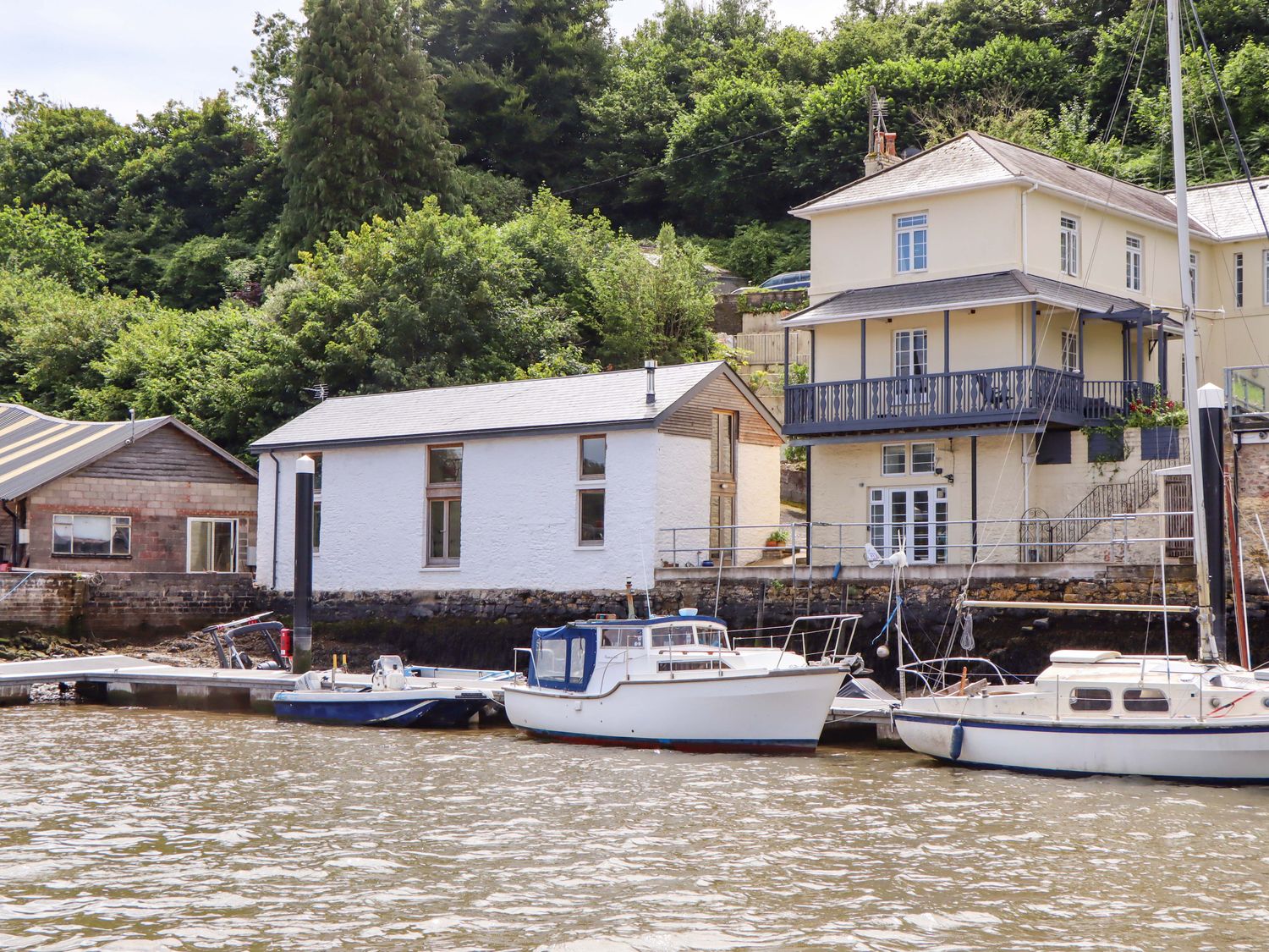 A view of houses and boats on the water at Dolphin Cottage Brixham