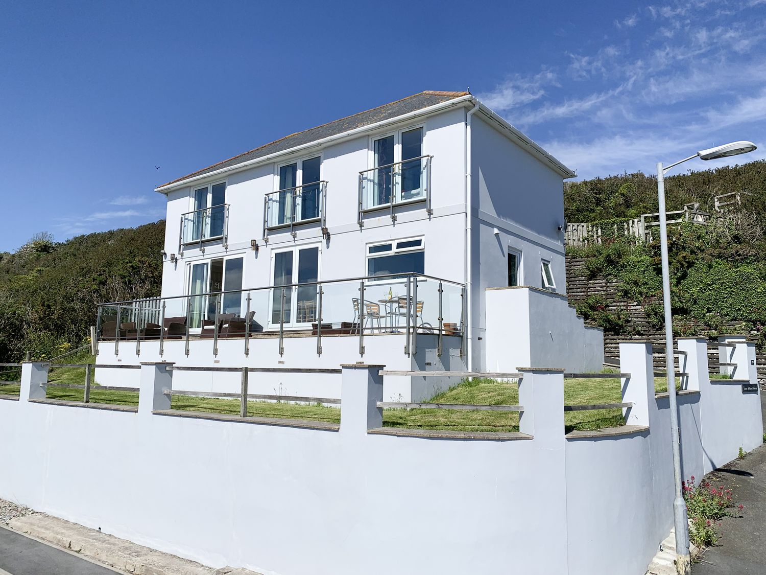 A house with balconies and a garden at Looe Island View in Downderry