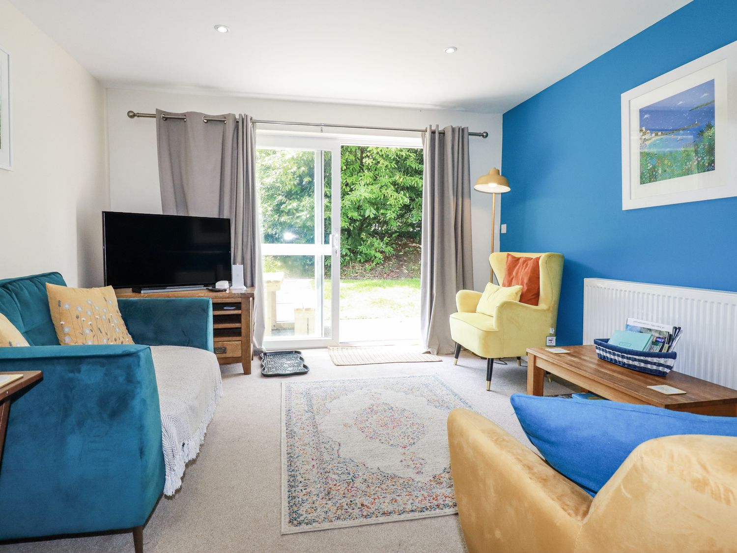 A living room with a tv and a sofa at 64 St Columb Road