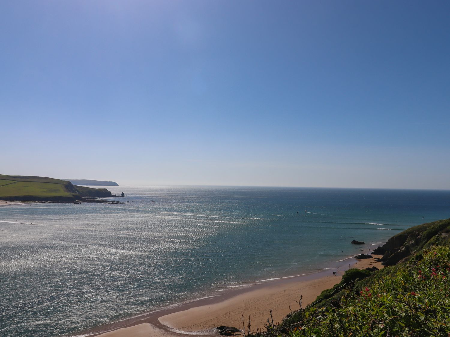 A coastal view with a sandy beach cliffs and ocean at 14 Burgh Island Causeway in Bigbury-On-Sea