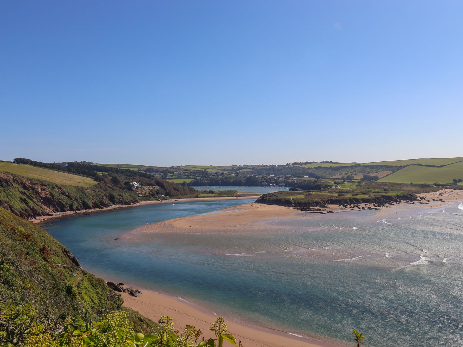 A coastal landscape with a river flowing into the sea and sandy beaches at 14 Burgh Island Causeway in Bigbury-On-Sea