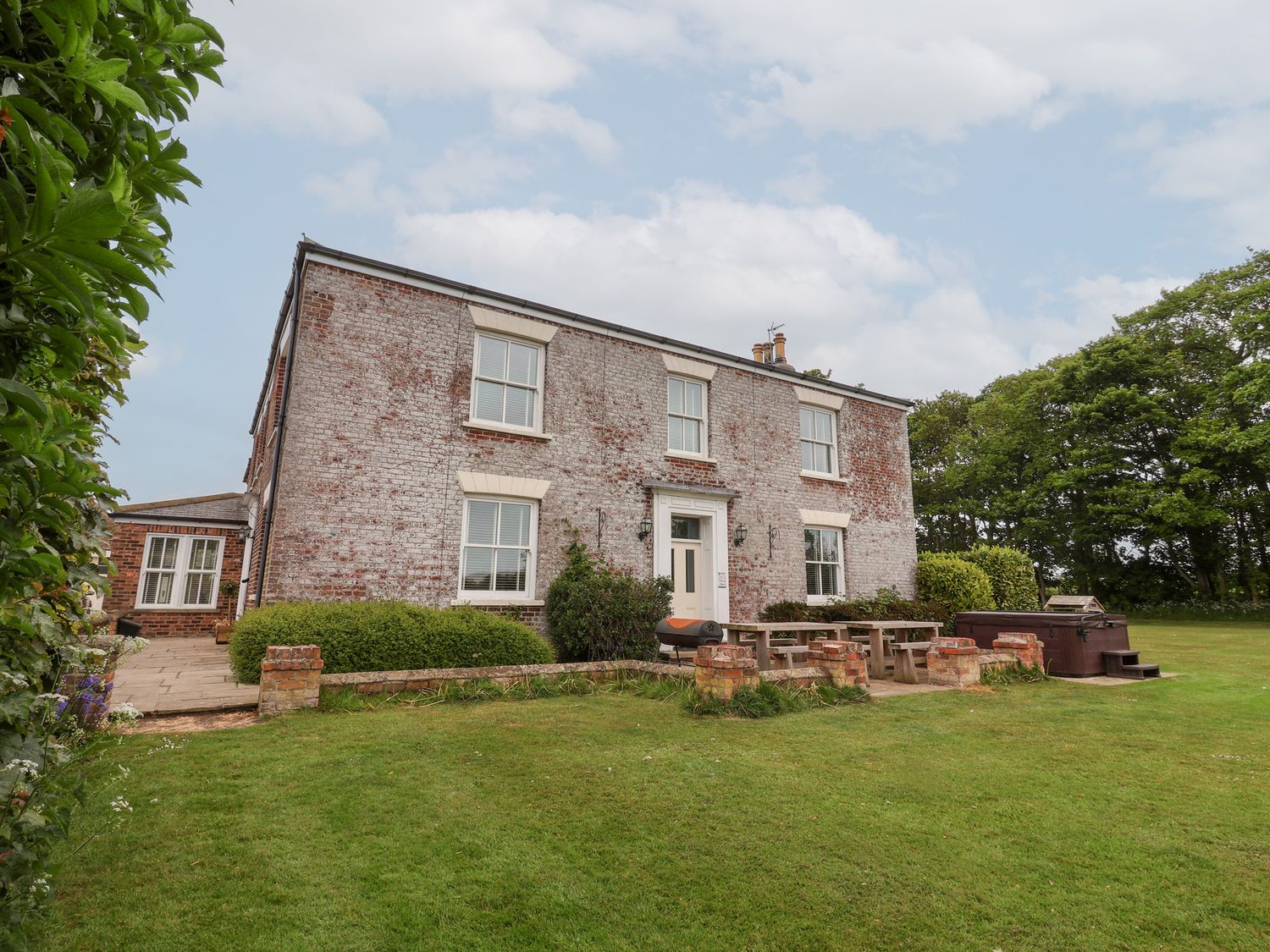 A house with a garden and patio area at The Grange in Flamborough