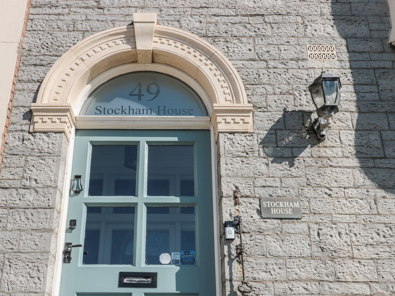 The front door of Stockham House with the number 49 above it on a stone building at 49 Esplanade Burnham-On-Sea