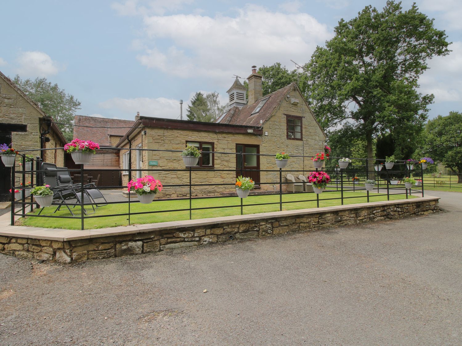 An exterior view of a house with planters at Stables Cottage in Shobdon