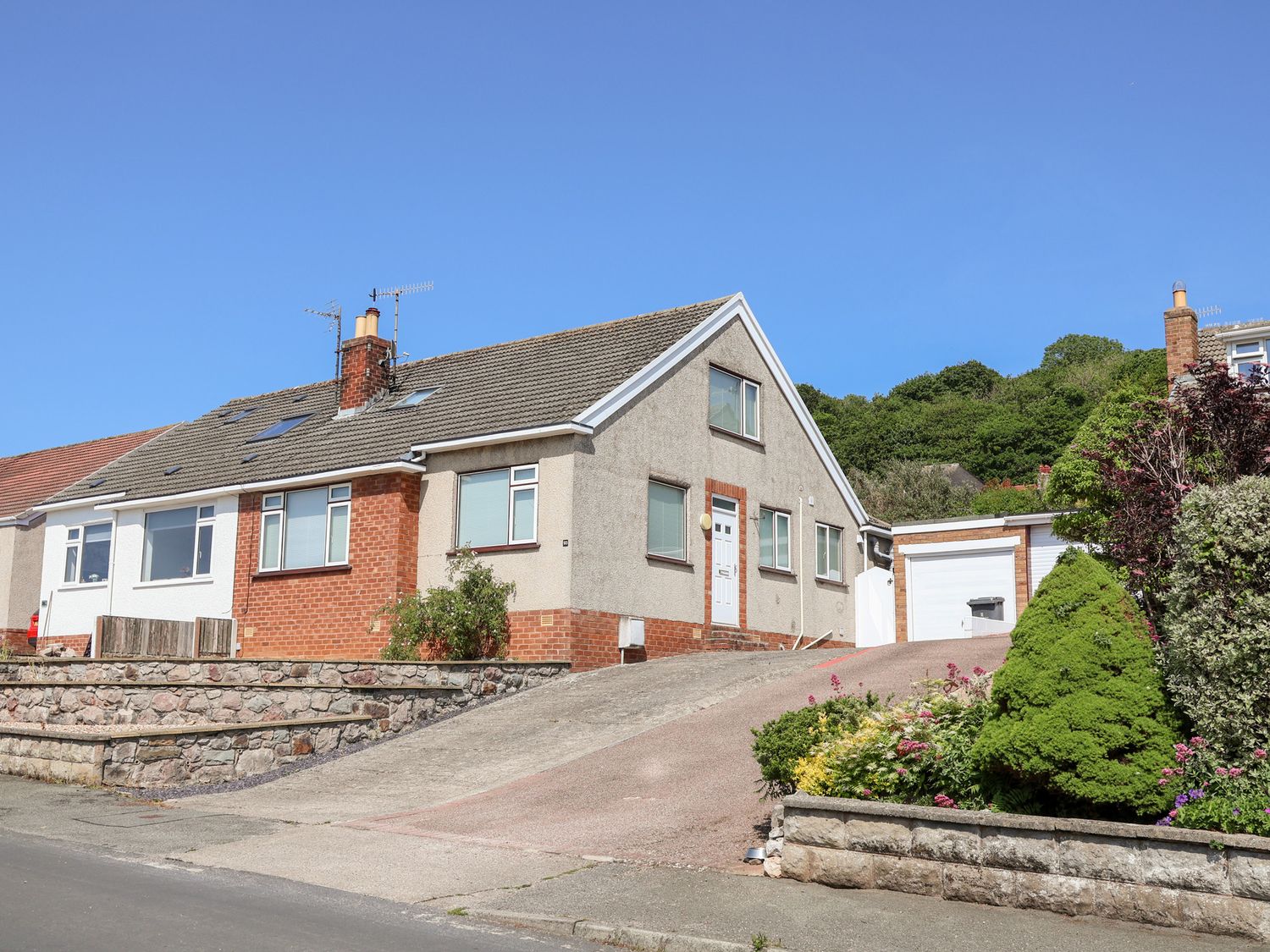 A house with a garage and garden at Bryn Bach in Rhos-On-Sea