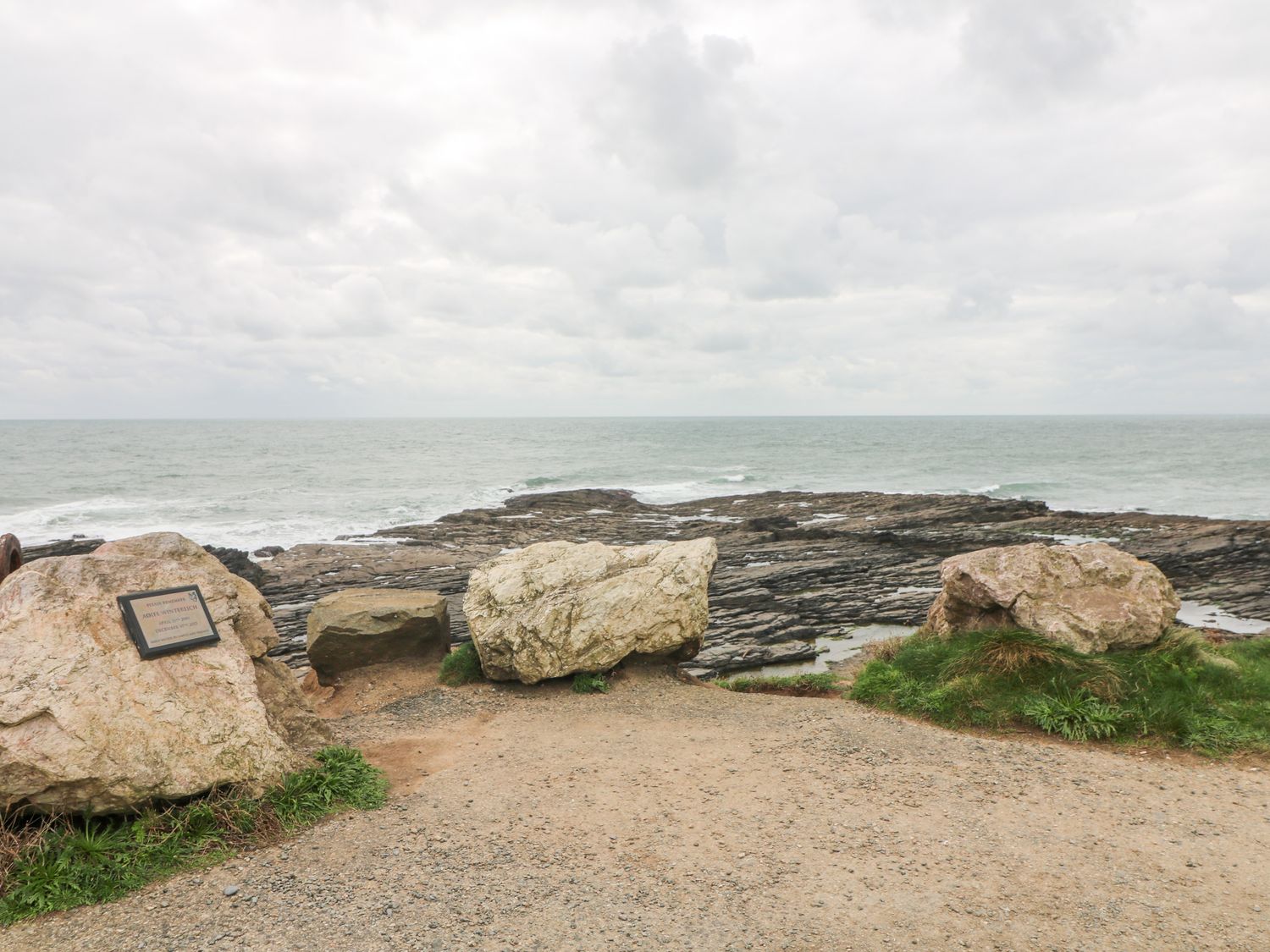A rocky coastline with large stones and a plaque overlooking the sea at Old Field House Slade near Fethard-On-Sea County Wexford