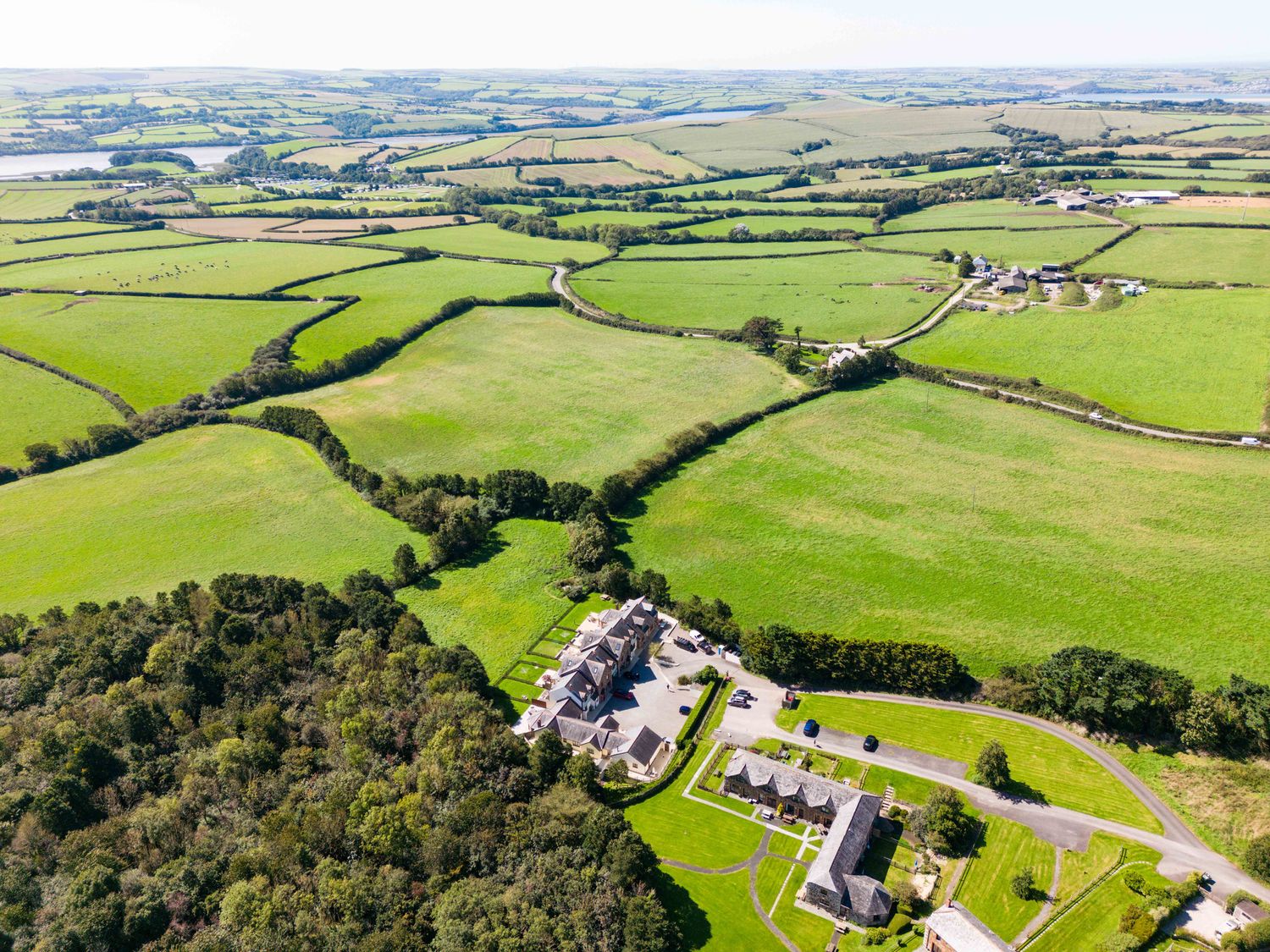 Aerial view of fields trees and buildings at Chy Pol in St Minver
